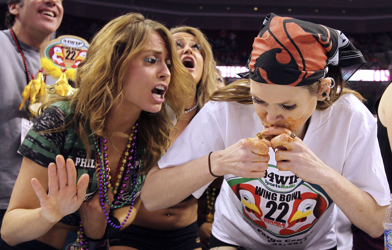 From left: A wingette cheers on contestant Molly Schuyler, of Omaha, Neb., during the Sportsradio 94 WIP's Wing Bowl 22 held at the Wells Fargo Center in Philadelphia, on Jan. 31, 2014. (Alejandro A. Alvarez&mdash;Philadelphia Daily News/AP)