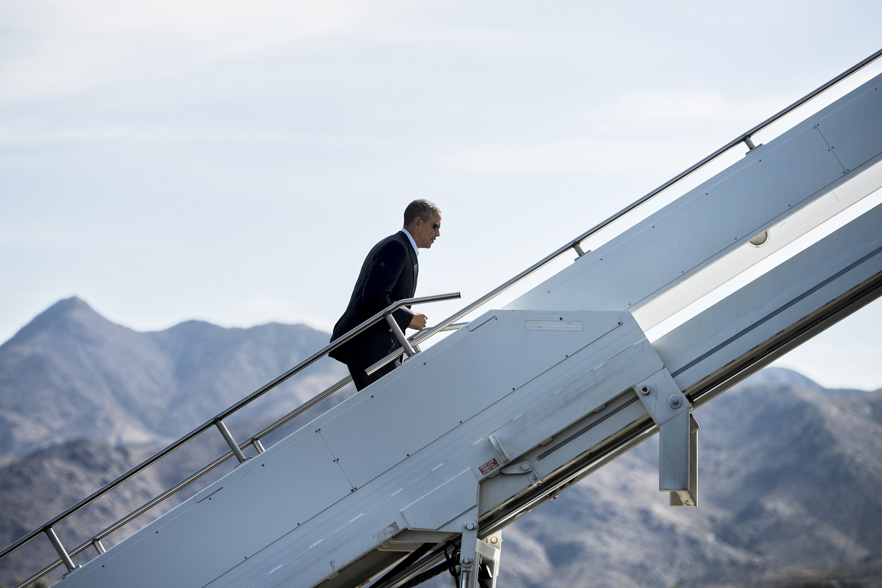 US President Barack Obama boards Air Force One at Palm Springs International Airport, Feb. 17, 2014 in Palm Springs, California. President Obama is returning to Washington,DC after spending the holiday weekend golfing in California. (Brendan Smialowski—AFP/Getty Images)