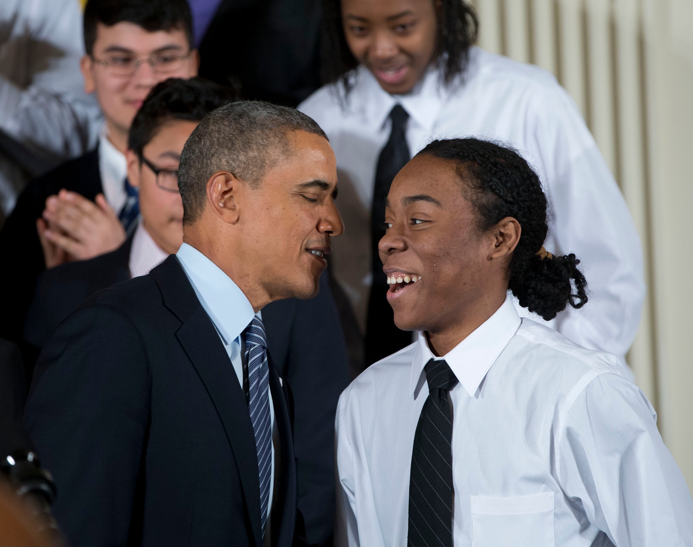 President Barack Obama speaks with Christian Champagne, 18, a senior at Hyde Park Career Academy in Chicago, who introduced him before launching a new initiative to provide greater opportunities for young black and Hispanic men called 'My Brother's Keeper' Thursday, Feb. 27, 2014, in the East Room of the White House in Washington.