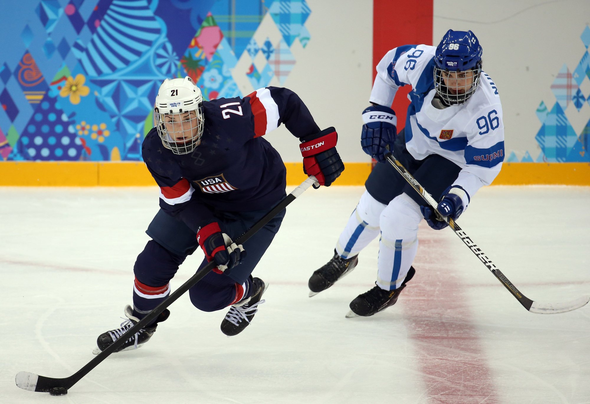 From left: U.S. forward Hilary Knight (21) skates ahead of Finland's Emma Nuutinen (96) during the second period in a women's hockey game at the 2014 Winter Olympics in Sochi, on Feb. 8, 2014. (Brian Cassella&mdash;Zuma Press)