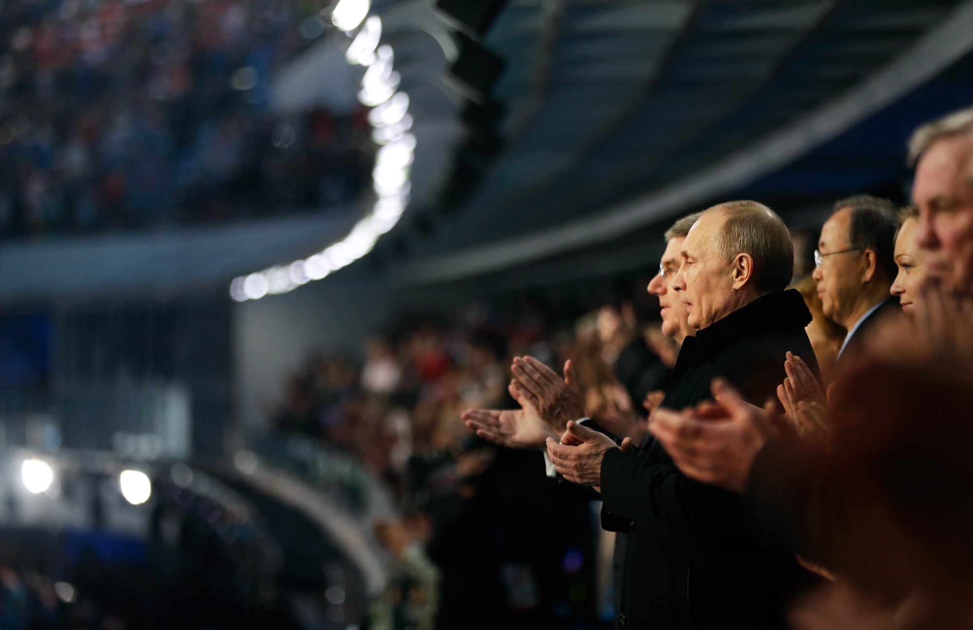 Russian President Vladimir Putin, right, and International Olympic Committee President Thomas Bach, left, applaud during the playing of the Russian national anthem.