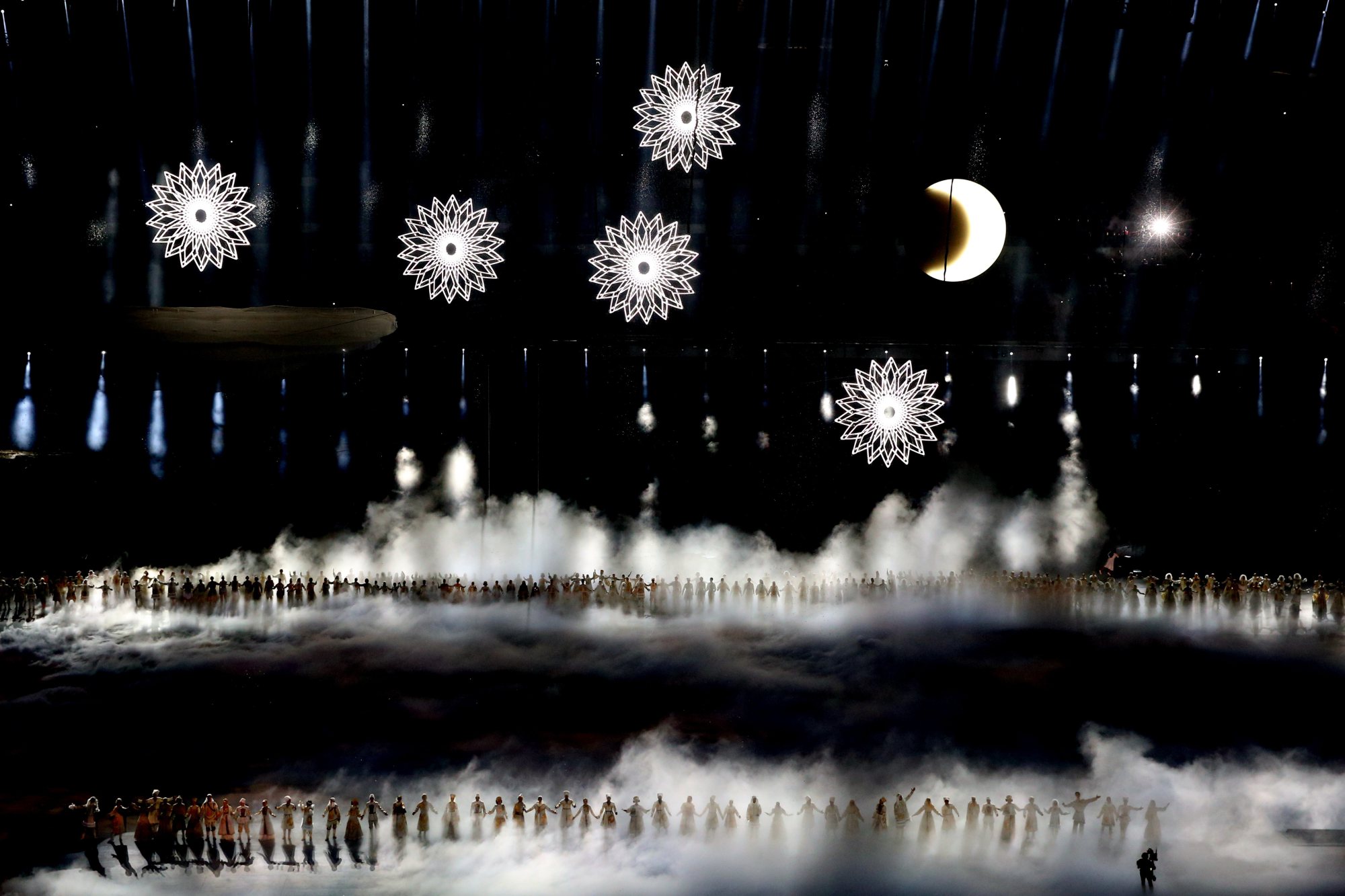 Snowflakes hover above performers of Voices of Russia.