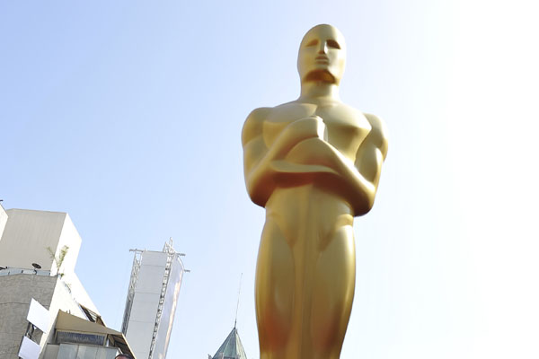 An Oscar statue stands on the red carpet
