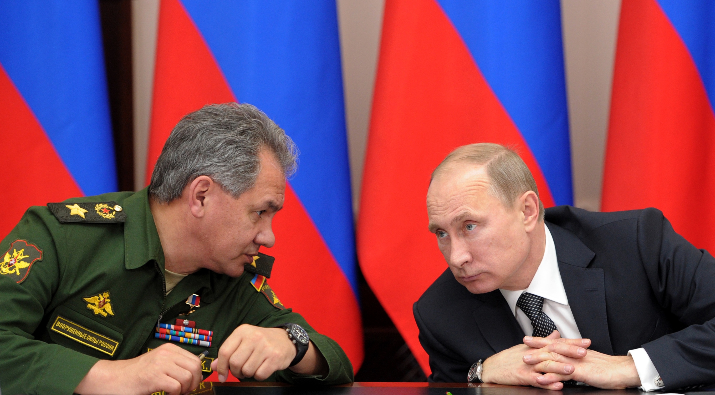 FILE - In this Friday, Nov. 15, 2013 file photo Russian President Vladimir Putin, right, and Defense Minister Sergei Shoigu attend a meeting while visiting the airborne troops school in the city of Ryazan, some 100 km (62.5 miles) southeast of Moscow, Russia. President Vladimir Putin on Wednesday, Feb. 26, 2014, ordered massive exercises involving most of its military units in western Russia amid tensions in Ukraine. (AP Photo/RIA-Novosti, Alexei Nikolsky, Presidential Press Service, File)
