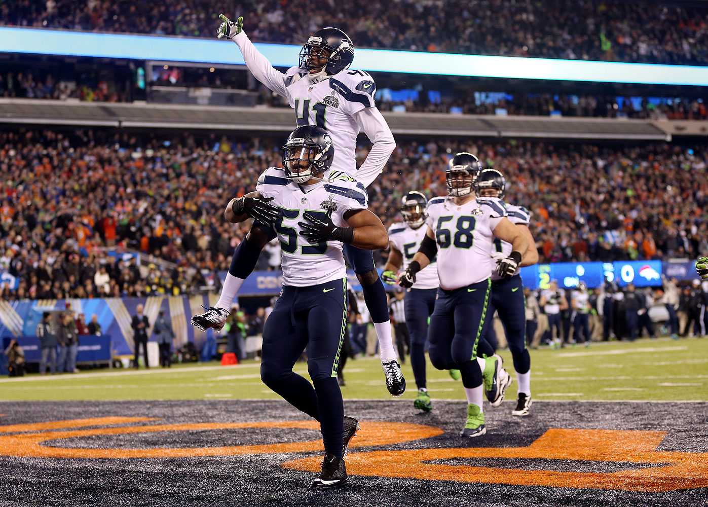 Outside linebacker Malcolm Smith #53 of the Seattle Seahawks celebrates his 69-yard touchdown with teammates after intercepting a pass thrown by quarterback Peyton Manning #18 of the Denver Broncos intended for running back Knowshon Moreno #27 in the second quarter during Super Bowl XLVIII at MetLife Stadium on Feb. 2, 2014 in East Rutherford, N.J. (Jeff Gross / Getty Images)
