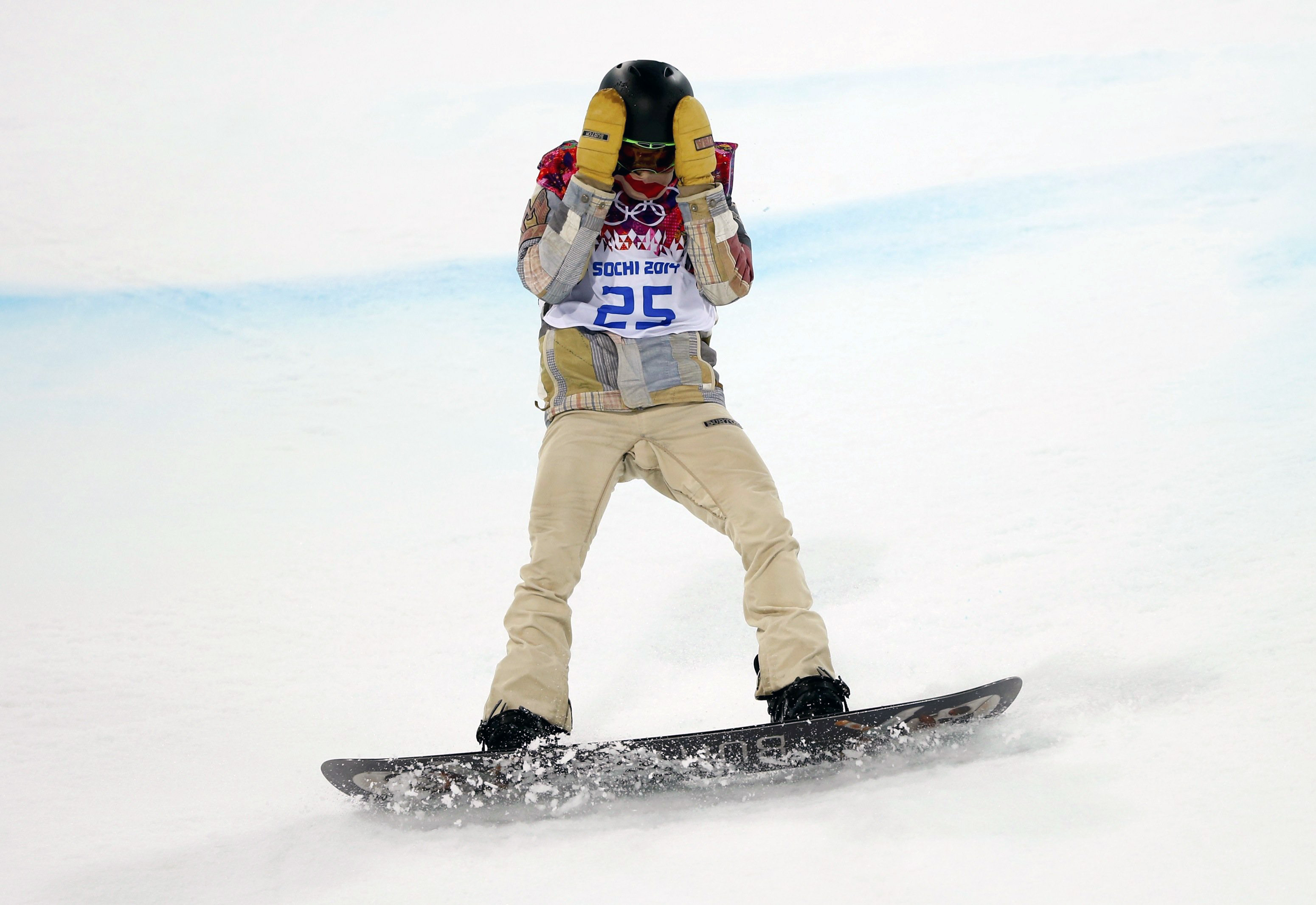 Shaun White of the U.S. reacts after crashing during the men's snowboard halfpipe final event at the 2014 Sochi Winter Olympic Games in Rosa Khutor