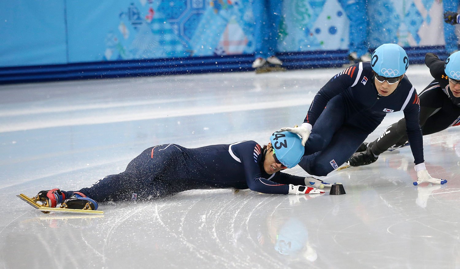 Sin Da-woon of South Korea, crashes as Lee Han-bin of South Korea goes down with him in a men's 1500m short track speedskating semifinal at the Iceberg Skating Palace during the 2014 Winter Olympics, Feb. 10, 2014, in Sochi.