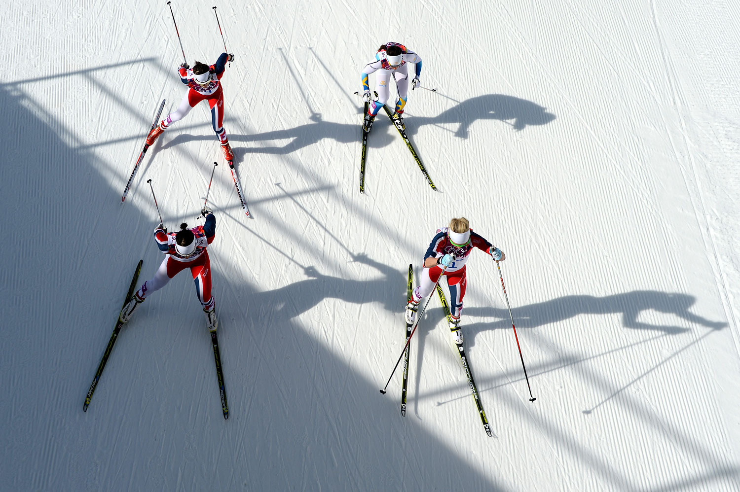 Norway's Therese Johaug, front right, competes with other athletes in the Women's Cross-Country Skiing 30km Mass Start Free.