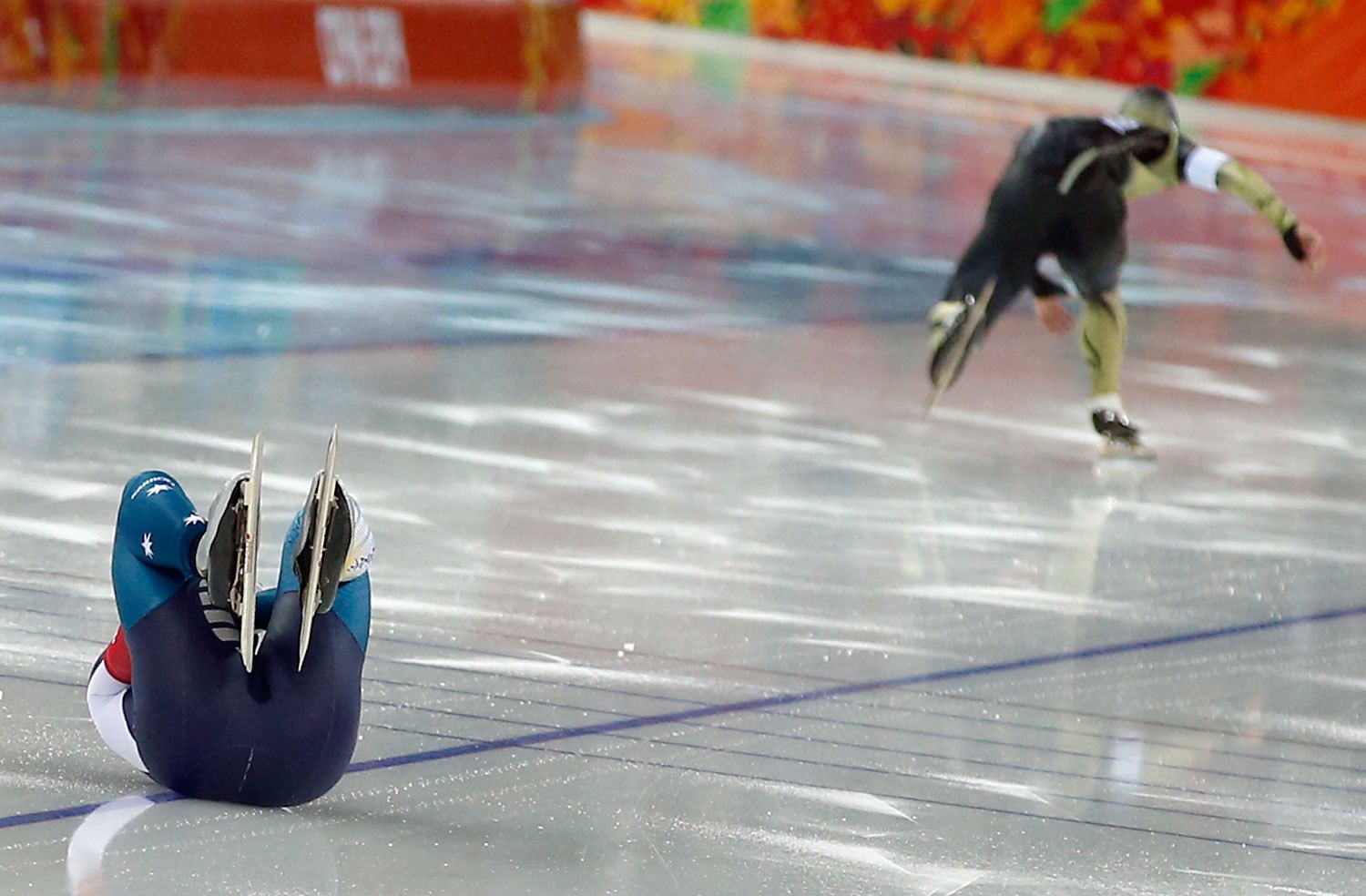 Australia's Daniel Greig, left, crashes in the first heat of his men's 500-meter speedskating race against Yuya Oikawa of Japan at the Adler Arena Skating Center at the 2014 Winter Olympics, Feb. 10, 2014, in Sochi.