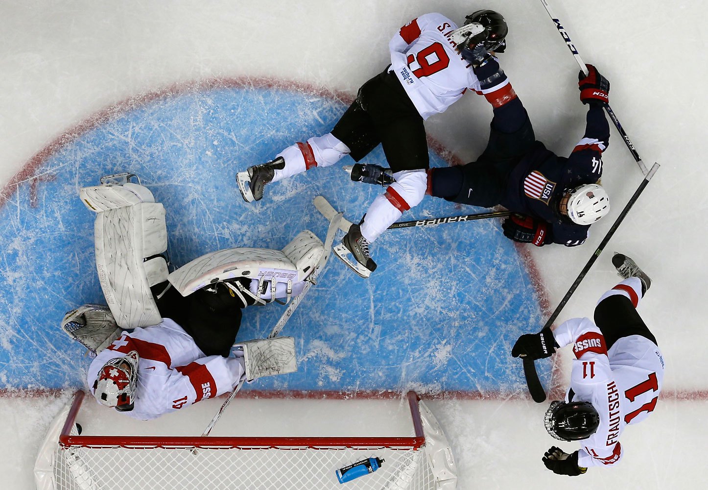 The puck sits in the net behind Switzerland's goalie Florence Schelling after a goal by Team USA's Amanda Kessel (not seen), during the first period of their women's preliminary round hockey game at the Sochi 2014 Winter Olympic Games Feb. 10, 2014.