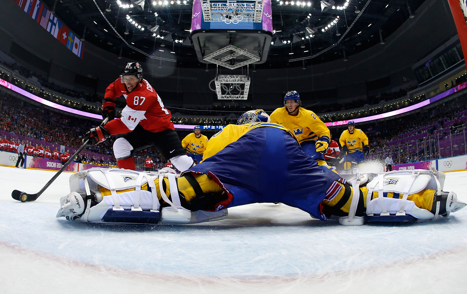 Canada's Sidney Crosby (87) scores on a breakaway past Sweden's goalie Henrik Lundqvist during the second period of their men's ice hockey gold medal game.