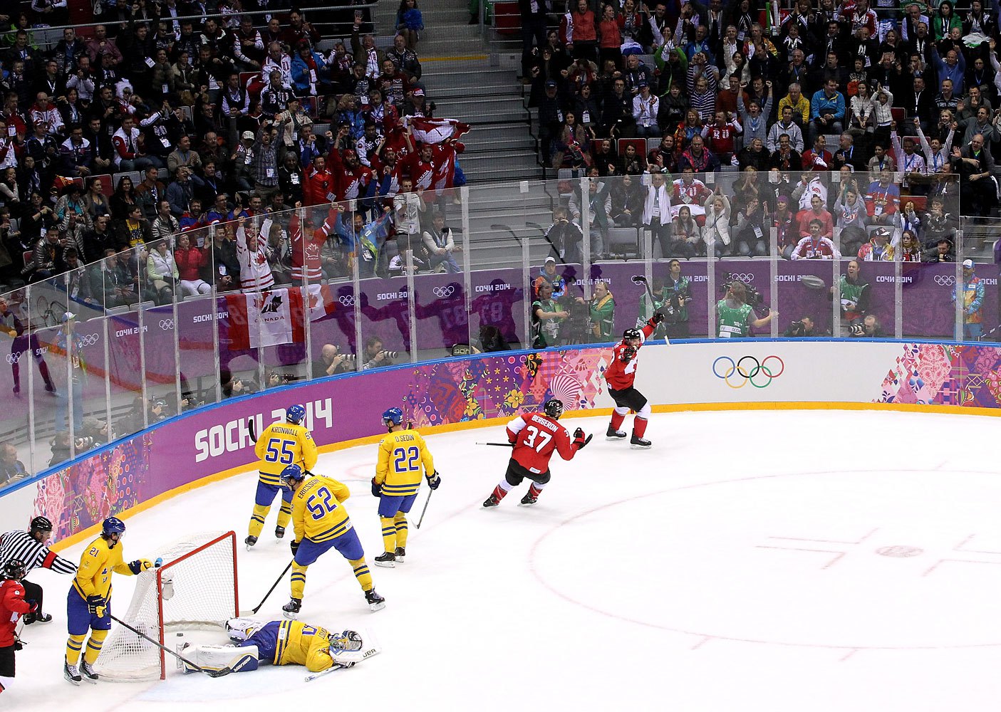 Sidney Crosby #87 of Canada celebrates with teammate Patrice Bergeron #37 after scoring a second-period goal against Henrik Lundqvist #30 of Sweden.
