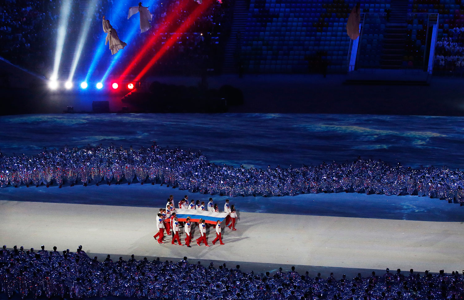 The Russian flag is carried into the stadium.