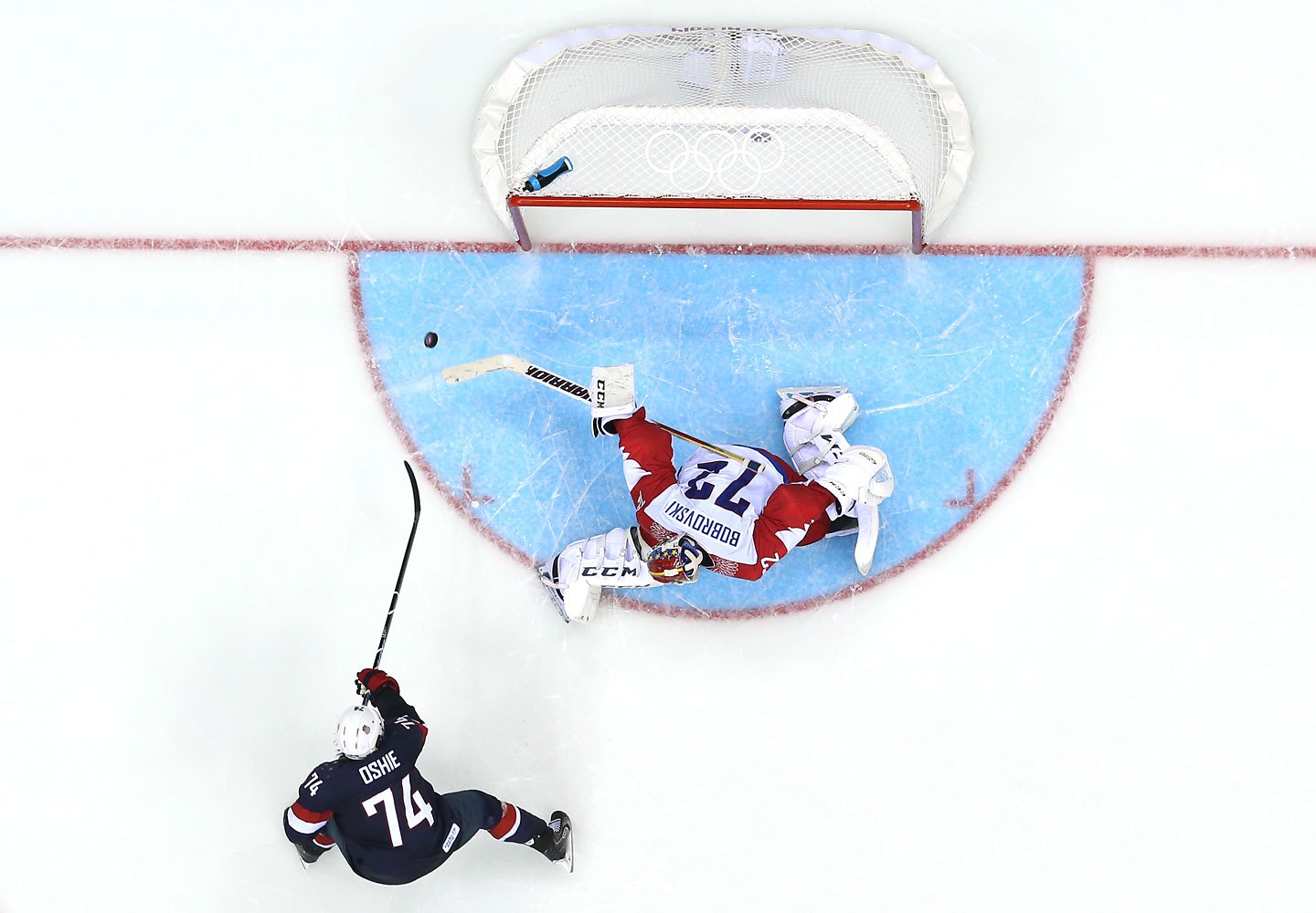 .J. Oshie #74 of the United States shoots during a shootout against Sergei Bobrovski #72 of Russia .