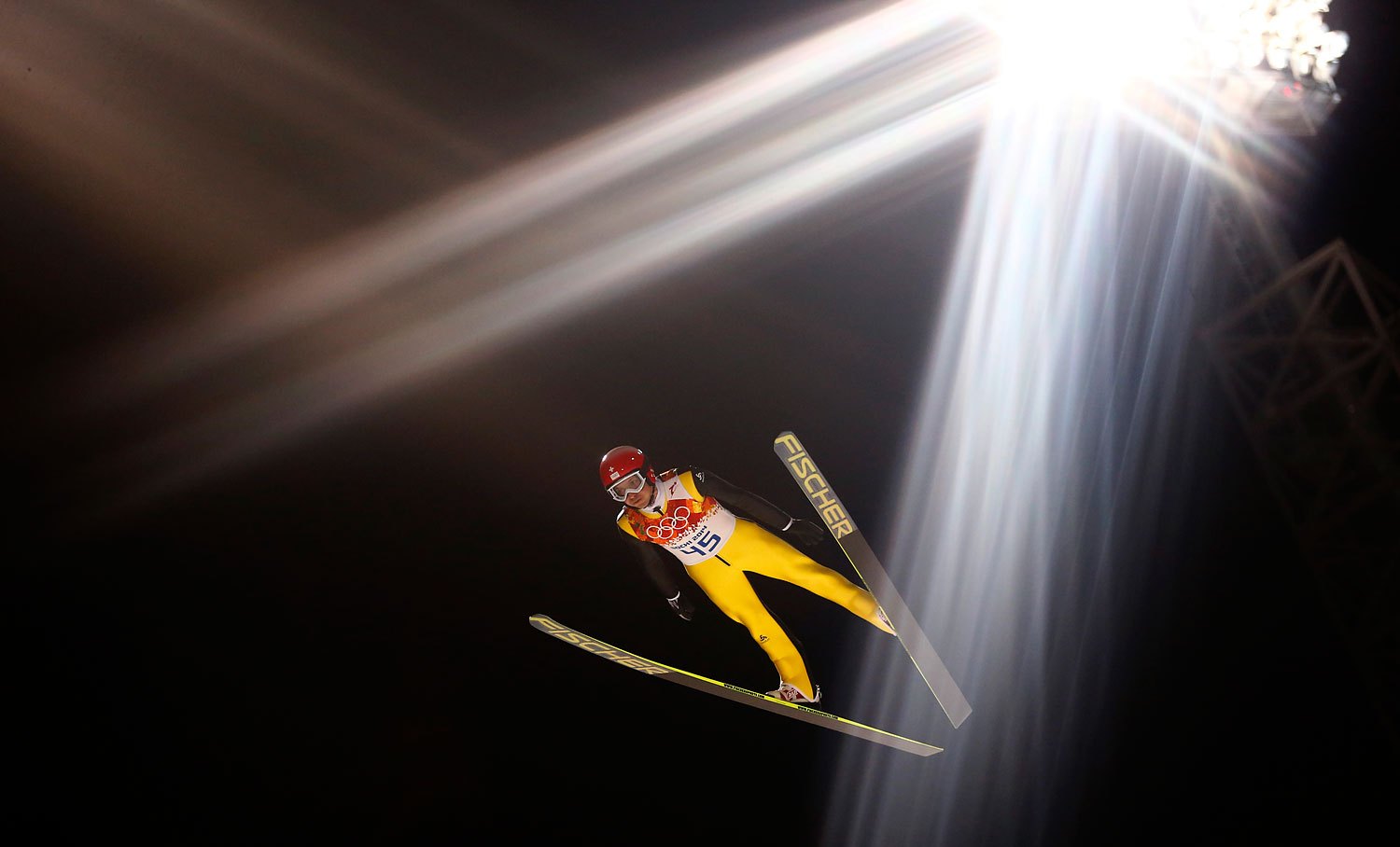 Switzerland's Simon Ammann soars through the air during the first round of the men's ski jumping large hill individual final.