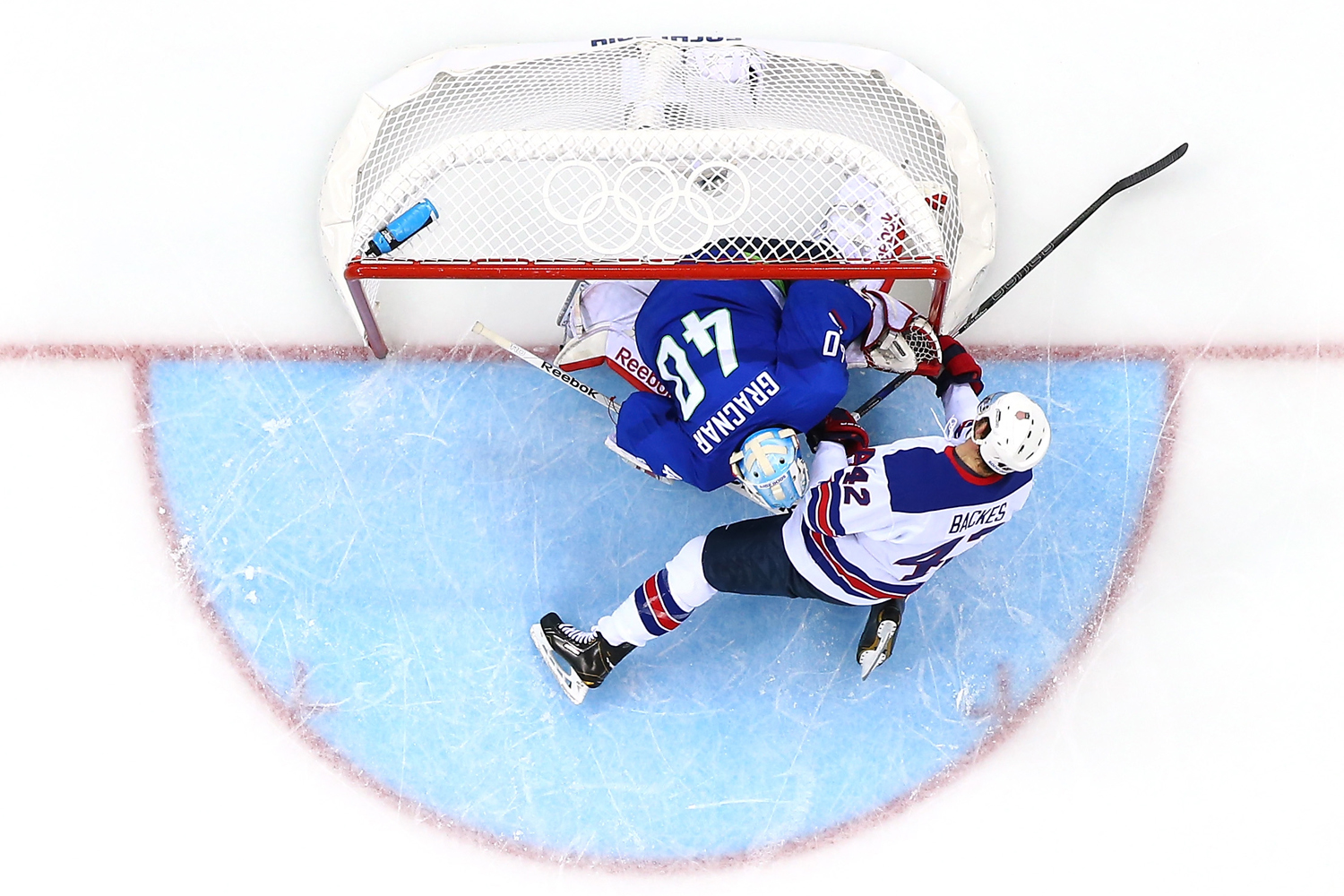 David Backes #42 of the United States collides with Luka Gracnar #40 of Slovenia in the second period during the Men's Ice Hockey Preliminary Round Group A game during the Sochi 2014 Winter Olympics at Shayba Arena on February 16, 2014 in Sochi, Russia.