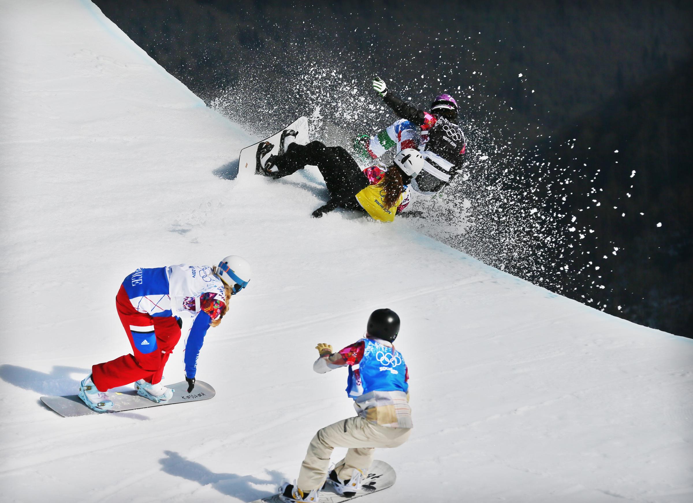 Michela Moioli of Italy (black bib) collides with Alexandra Jekova of Bulgaria (yellow) in front of Chloe Trespeuch of France (white) and Faye Gulini of the USA (blue) during the Women's Snowboard Cross final at Rosa Khutor Extreme Park at the Sochi 2014 Olympic Games, Krasnaya Polyana, Russia, Feb. 16, 2014.