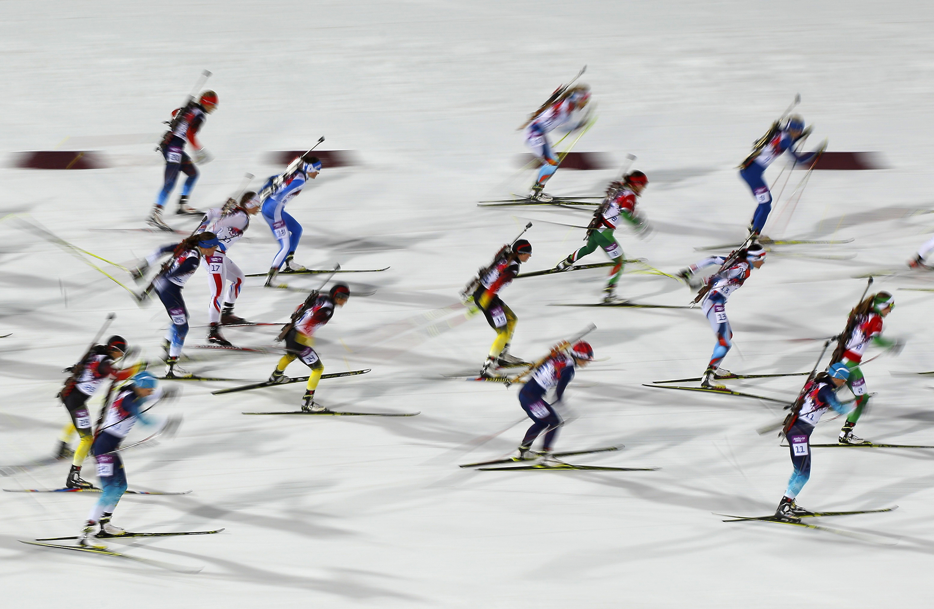 Skiers compete during the women's biathlon 12.5km mass start event.