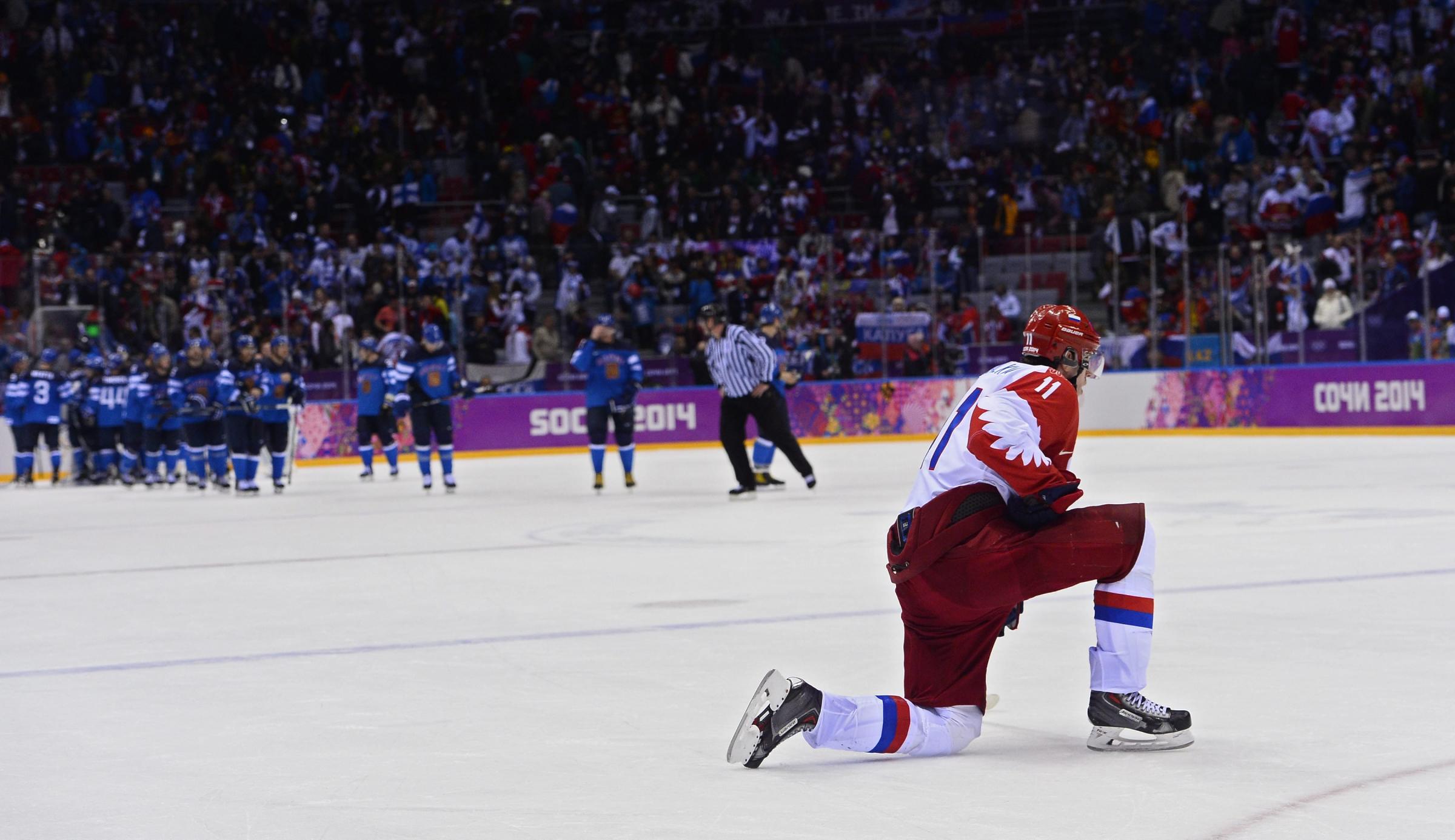 Yevgeni Malkin of Russia kneels on the ice after losing to Finland in the quarter final match between Finland and Russia.