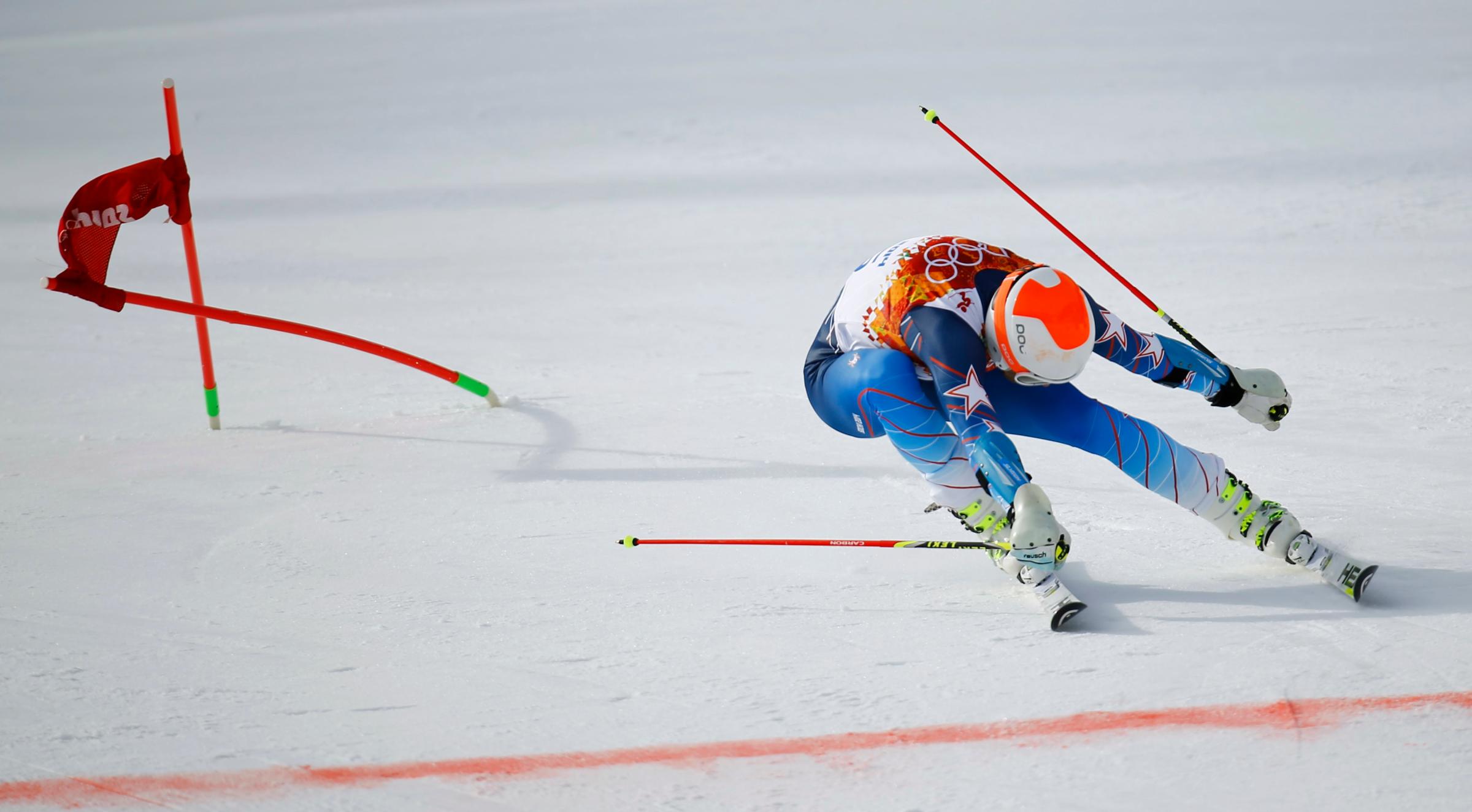 Bode Miller of the U.S. lunges towards the finish line during the first run of the men's alpine skiing giant slalom event.