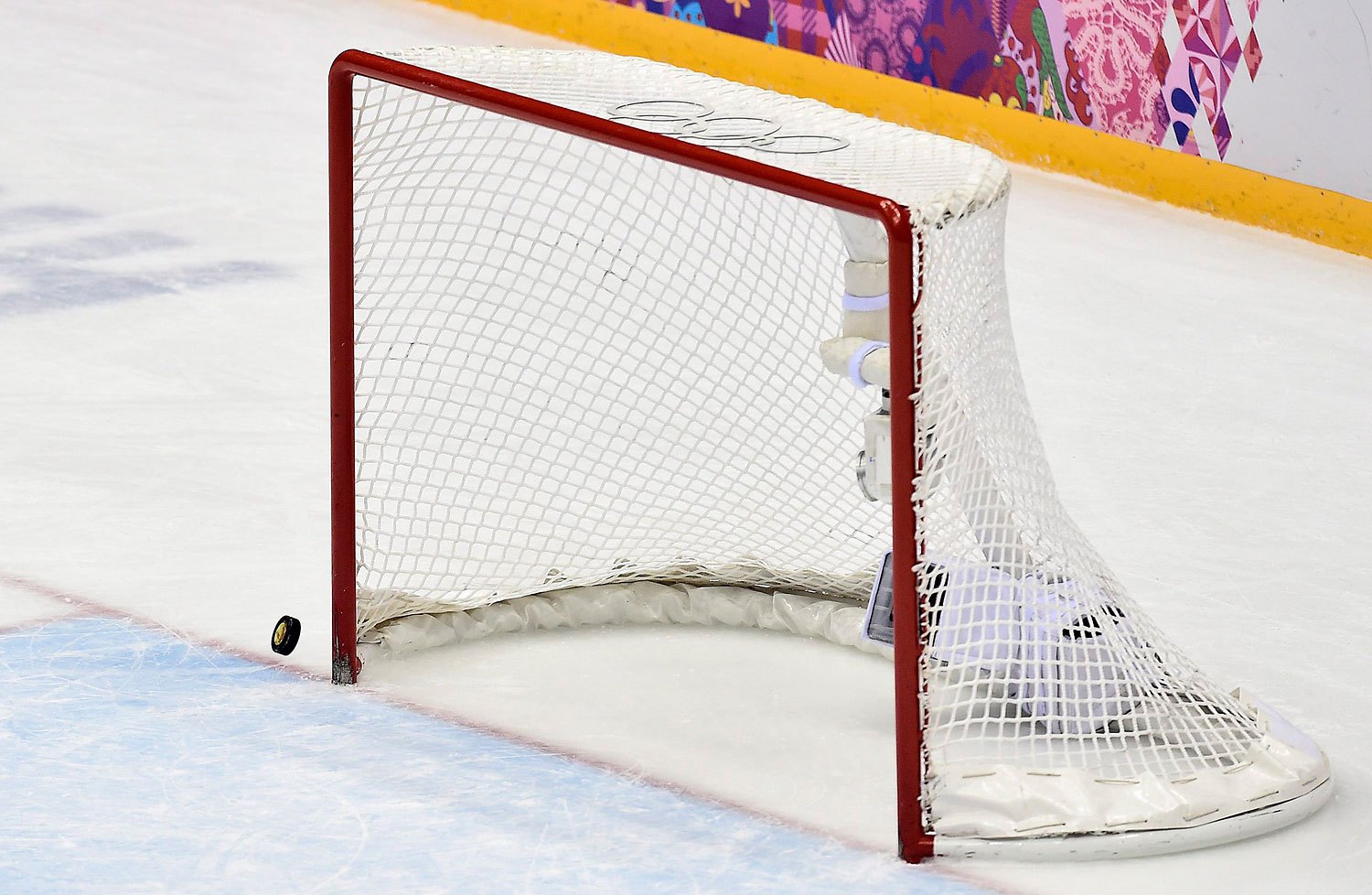 The puck hits the post with Canada's goalie pulled in the last minutes of the third period of the gold-medal women's hockey game between Canada and the United States,