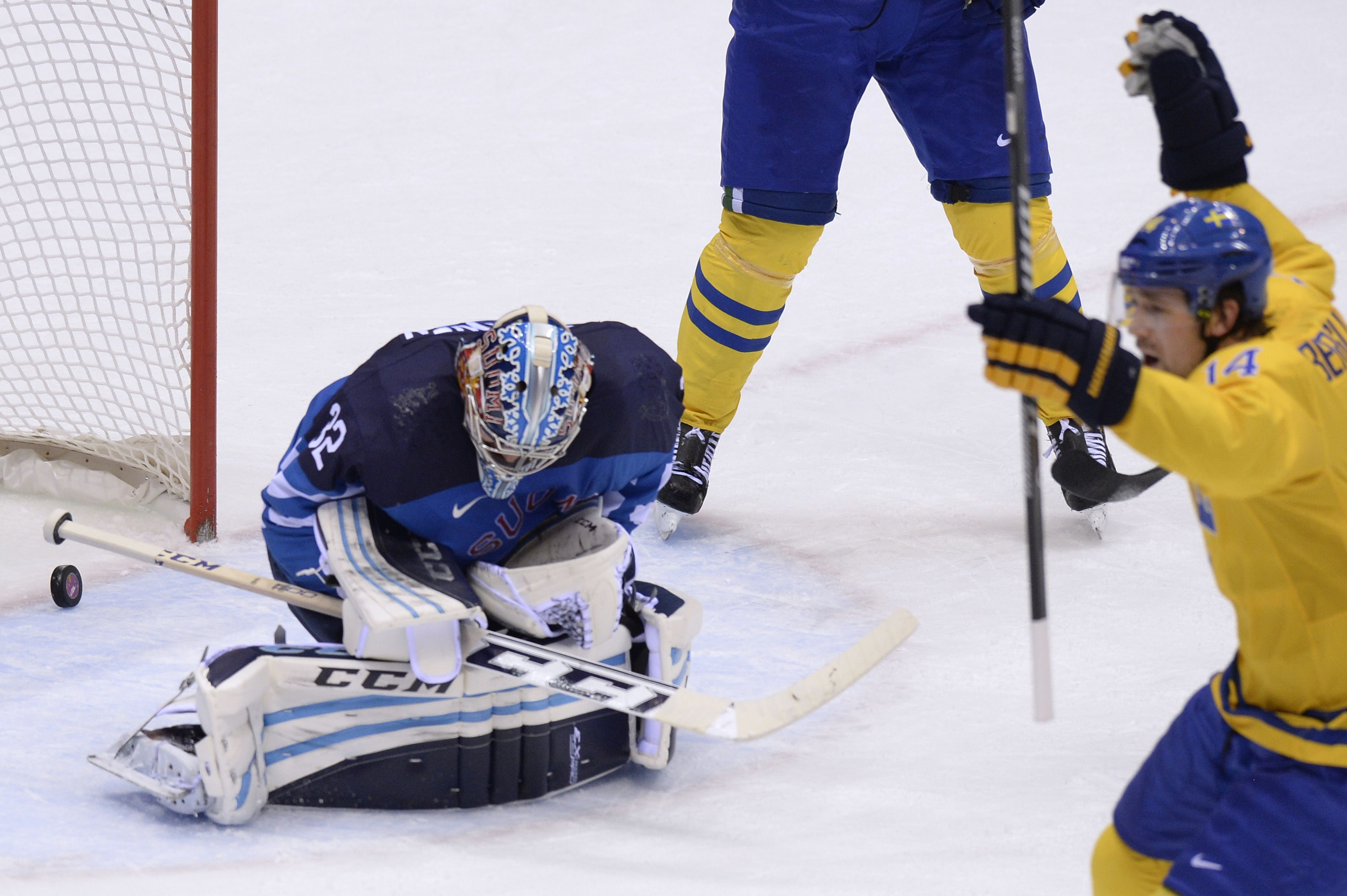 Finland's goalkeeper Kari Lehtonen (L) fails to stop a goal during the Men's Ice Hockey Semifinal match between Sweden and Finland.