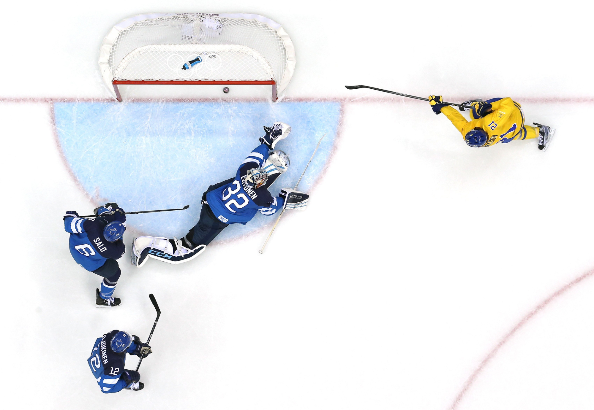 Loui Eriksson #21 of Sweden scores a scoend-period goal against Kari Lehtonen #32 of Finland during the Men's Ice Hockey Semifinal Playoff .