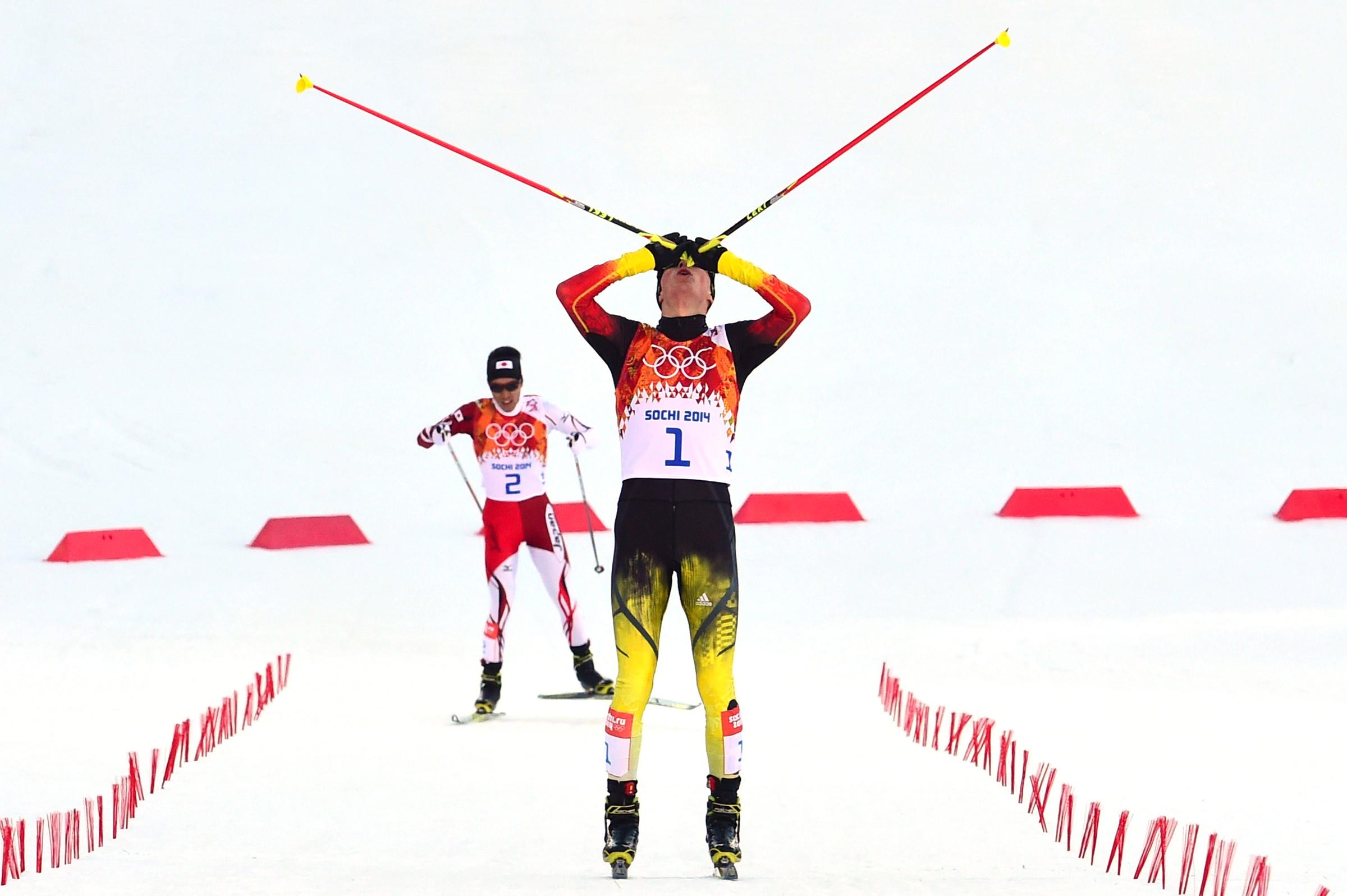 Gold medalist Eric Frenzel of Germany celebrates at the finish line of the Nordic Combined Individual NH / 10 km Cross-Country.
