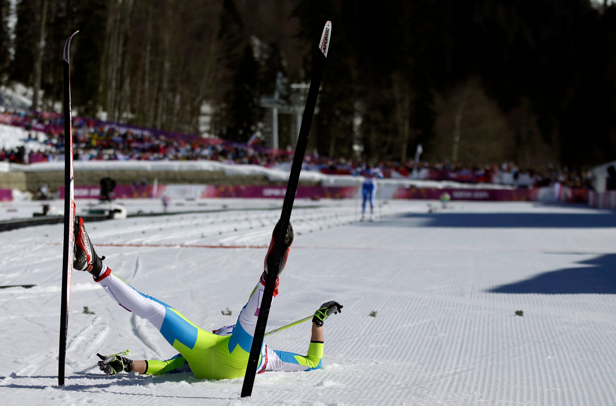 Slovenia's Barbara Jezersek lies on the snow after completing the women's 10K classical-style cross-country race.