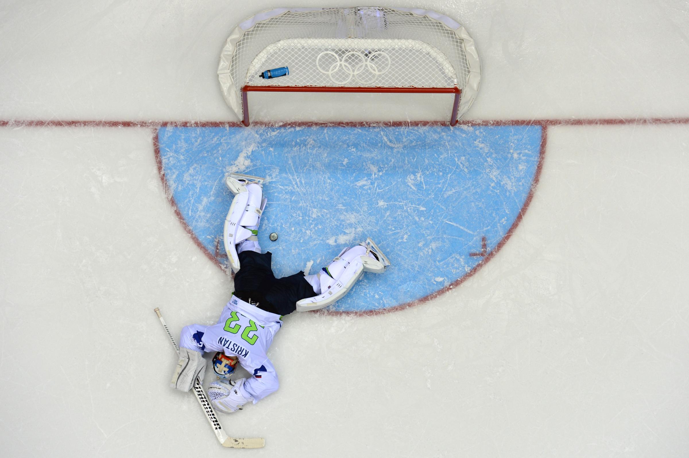 Slovenia's goalkeeper Robert Kristan reacts after Russia scored a fifth goal during the Men's Ice Hockey Group A match between Russia and Slovenia.