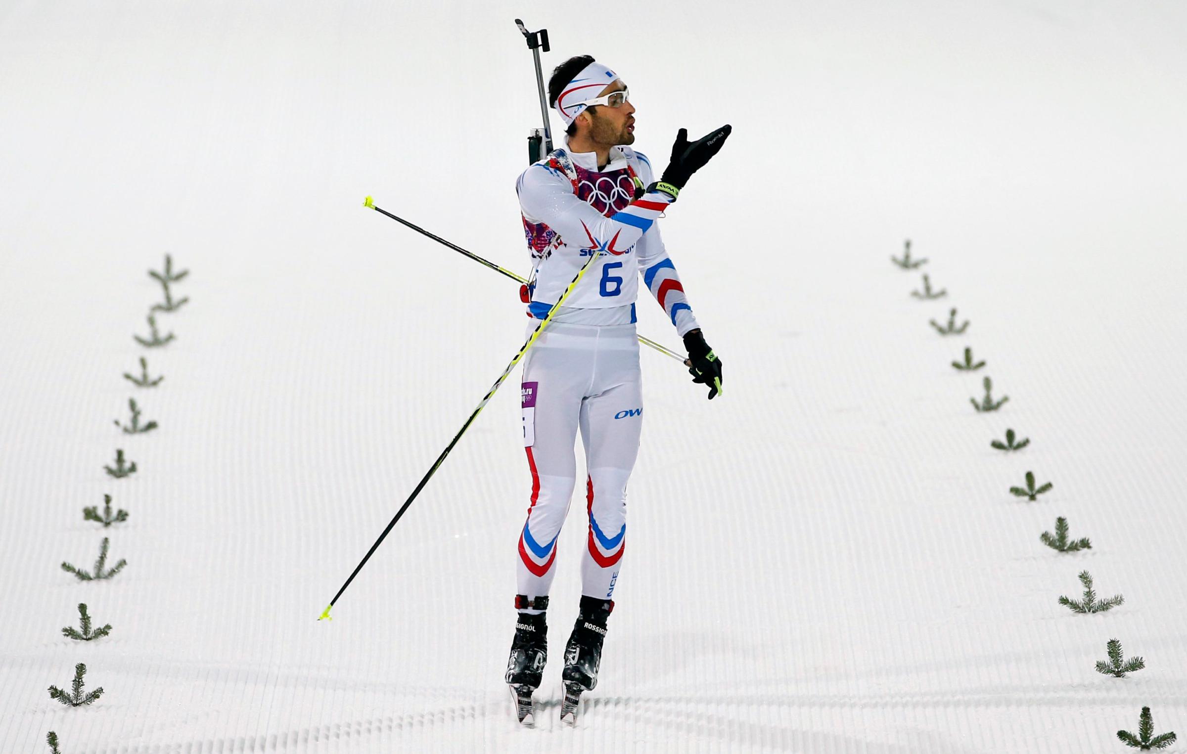 France's Martin Fourcade blows a kiss just before he crosses the line to win the men's biathlon 12.5k pursuit.