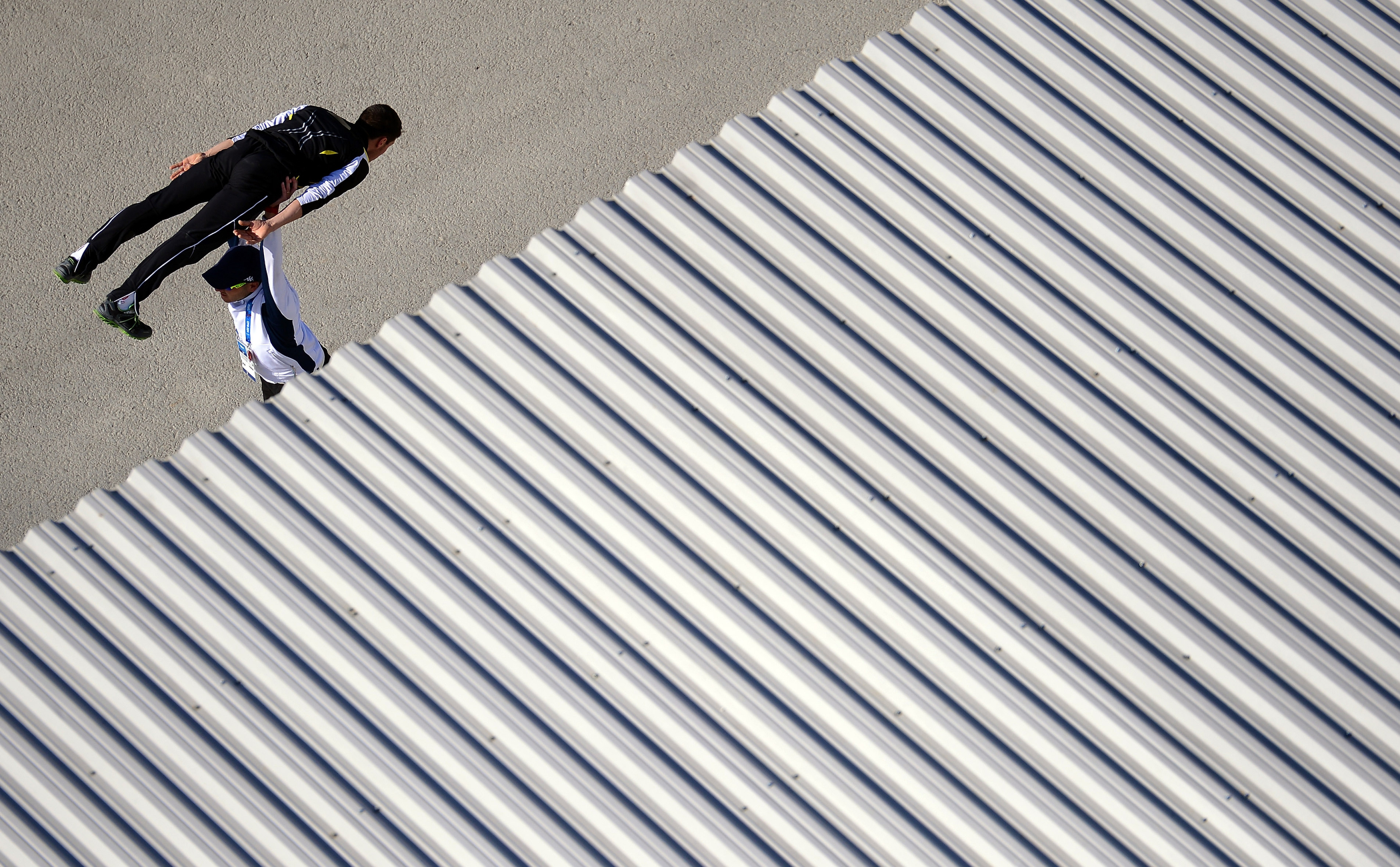 An athlete warm up with his coach prior to the Men's Individual Gundersen Large Hill/10 km Nordic Combined training on day 8 of the Sochi 2014 Winter Olympics at the RusSki Gorki Ski Jumping Center on Feb. 15, 2014 in Sochi, Russia.