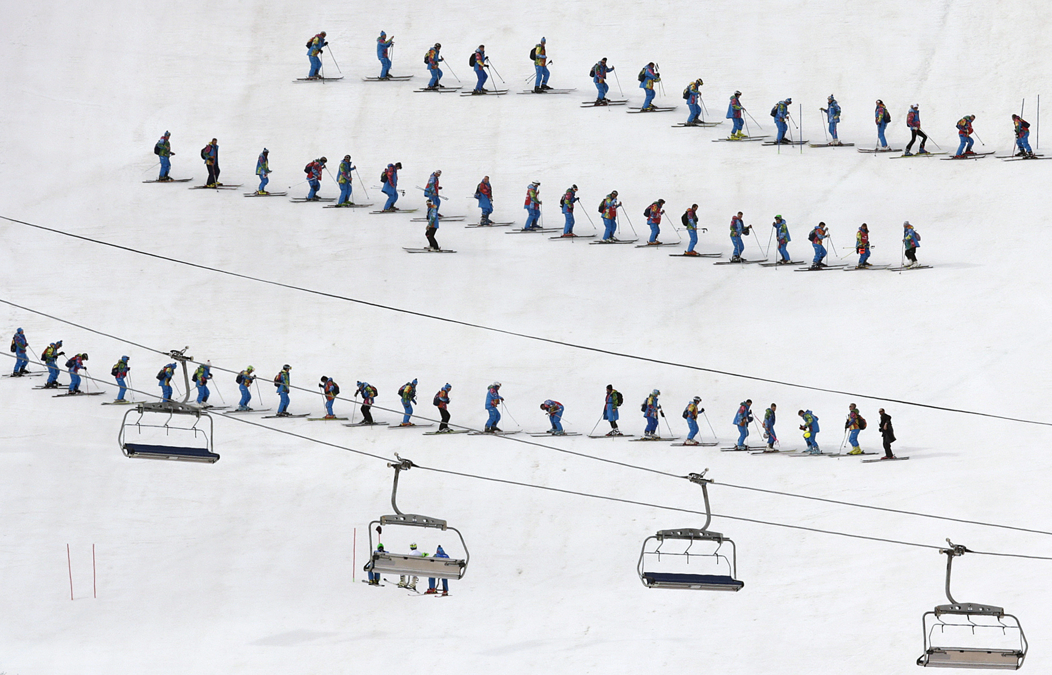 Slippers prepare the course ahead of the slalom portion of the men's supercombined at the Sochi 2014 Winter Olympics, Friday, Feb. 14, 2014, in Krasnaya Polyana, Russia.