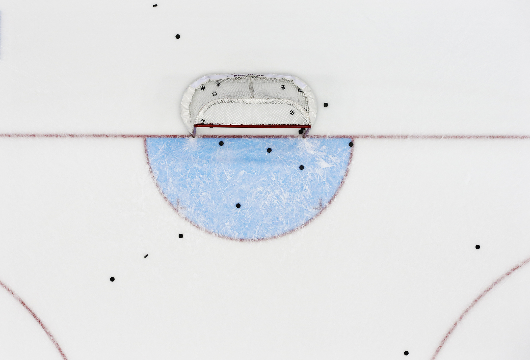 Pucks are left on the ice from the warm up session priot to the Men's Preliminary Round Group B match between Finland and Canada in the Ice Hockey tournament at the Sochi 2014 Olympic Games in Sochi, Russia, Feb. 16, 2014.