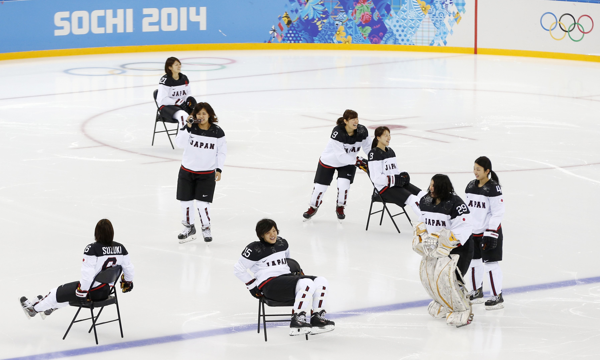 Players of Japan women's ice hockey team slide on chairs prior their practice session ahead of the 2014 Winter Olympics, Thursday, Feb. 6, 2014, in Sochi, Russia.