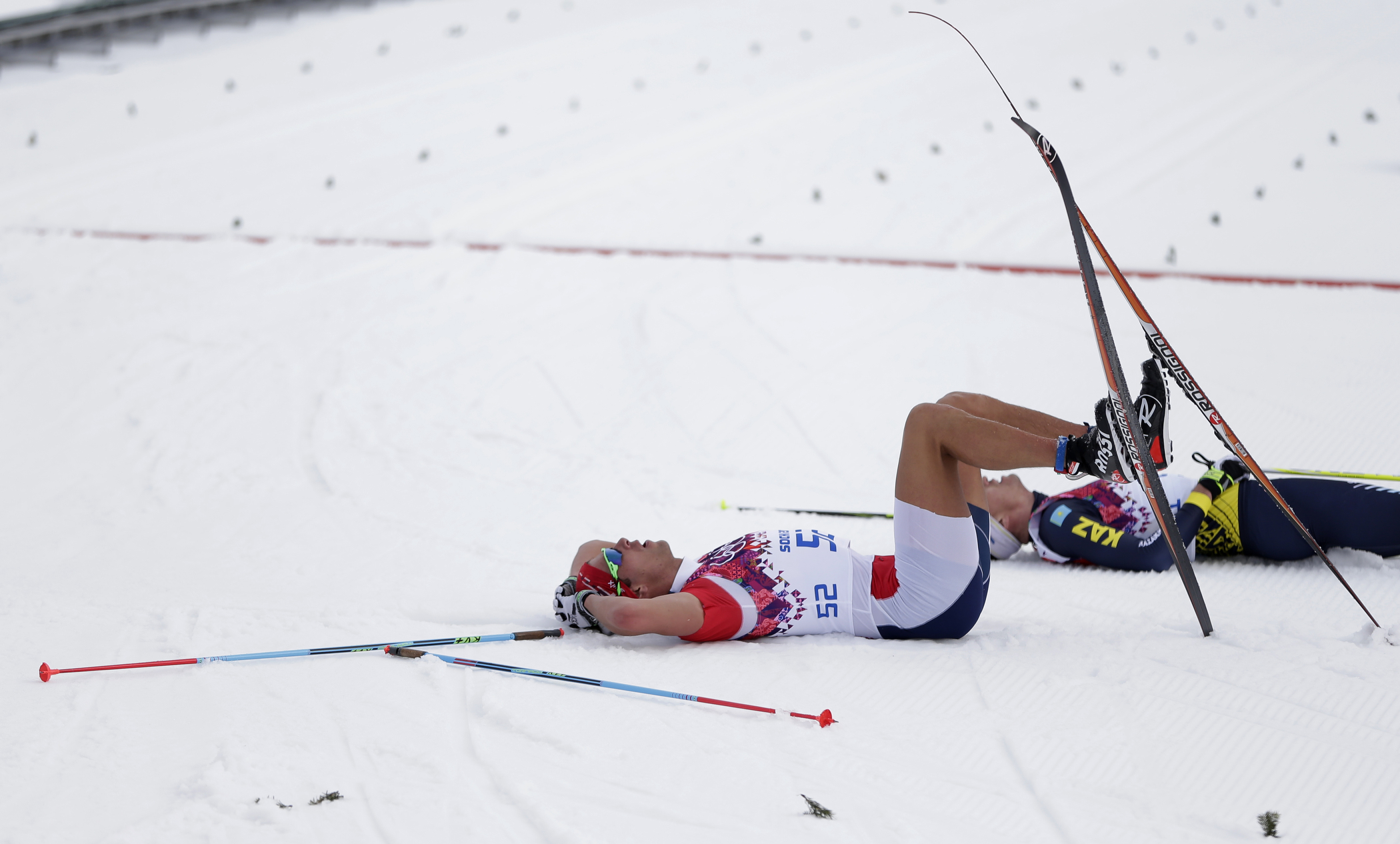 Norway's Chris Andre Jespersen rests in the finish area after competing in shorts in the men's 15K classical-style cross-country race at the 2014 Winter Olympics, Friday, Feb. 14, 2014, in Krasnaya Polyana, Russia.
