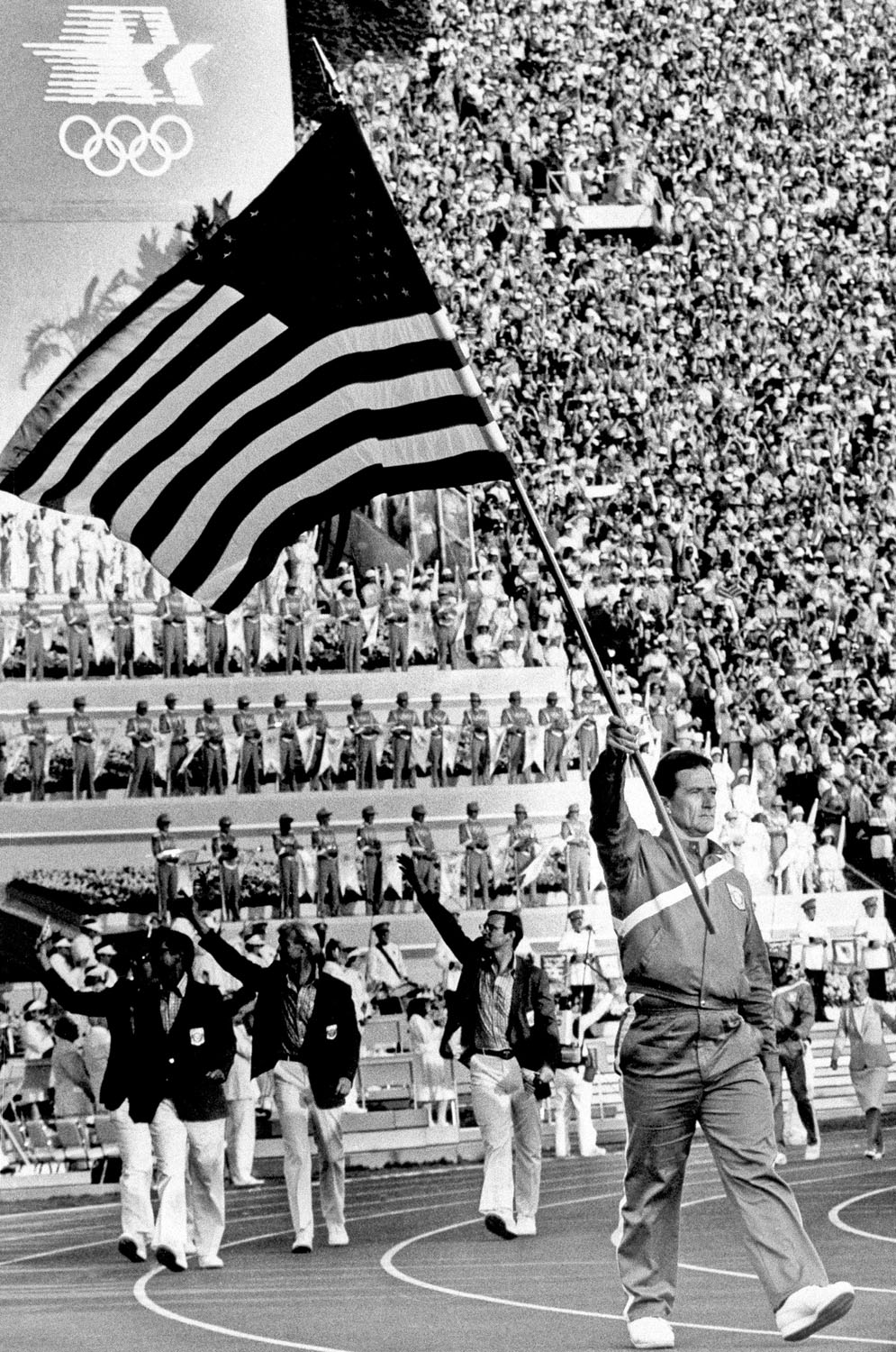 Ed Burke, a hammer thrower, bears the flag of the United States, as the team marches into the Coliseum, during the opening ceremonies of the 23rd Summer Olympics in Los Angeles, July 28, 1984.