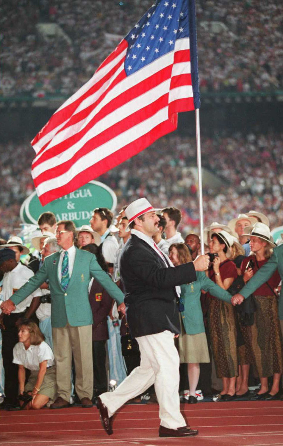 US Olympic wrestler Bruce Baumgartner carries the American flag during the opening ceremony at the Olympic Stadium in Atlanta in 1996.
