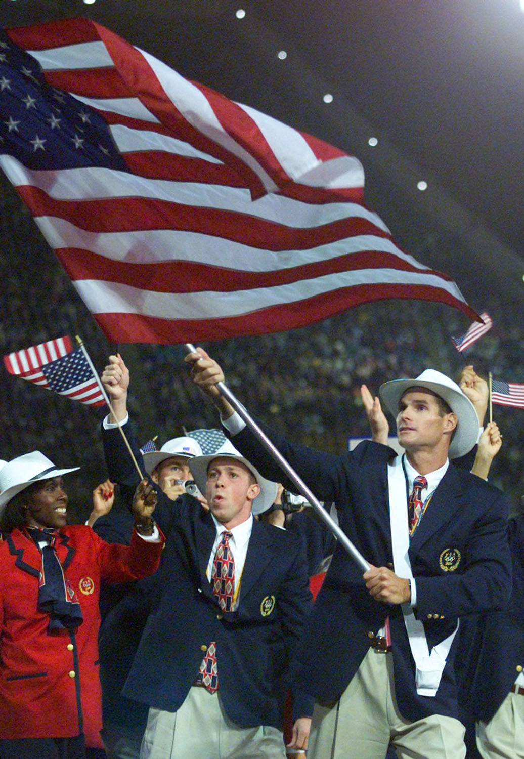 American canoeist Cliff Meidl carries his country's flag during the opening ceremony of Sydney's Olympic Games, Sept. 15, 2000.