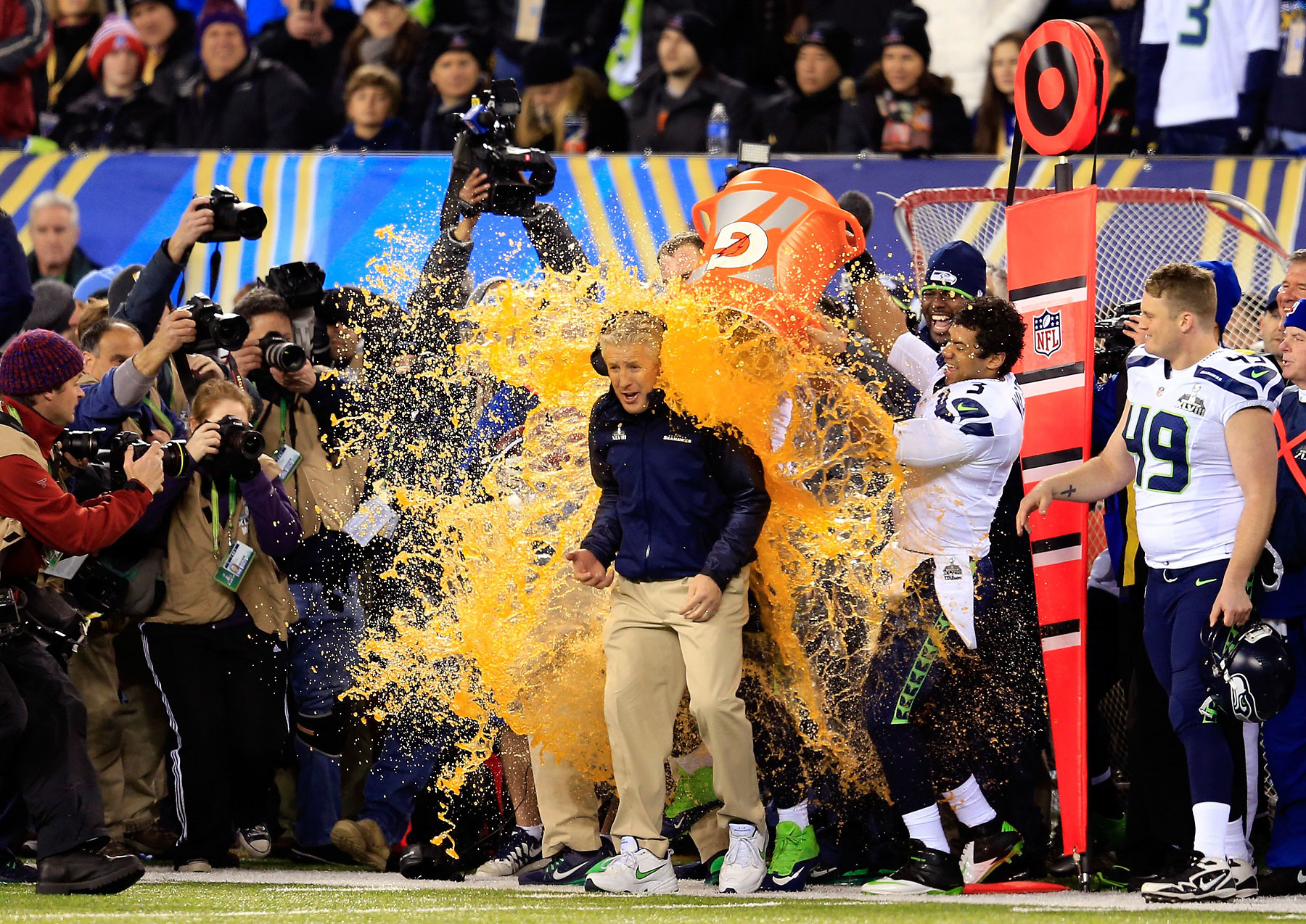 Tight end Zach Miller and quarterback Russell Wilson of the Seattle Seahawks dump Gatorade on head coach Pete Carroll in the fourth quarter of Super Bowl XLVIII.