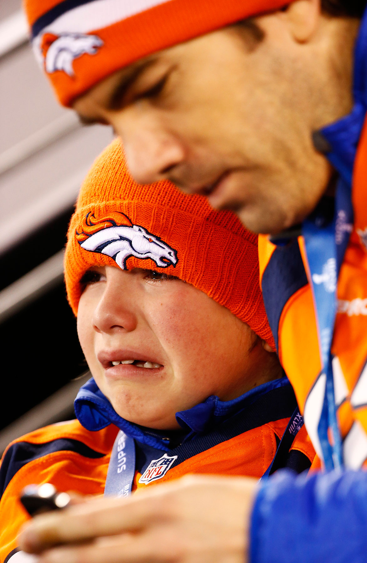 A young Denver fan cries during the second quarter of Super Bowl XLVIII.