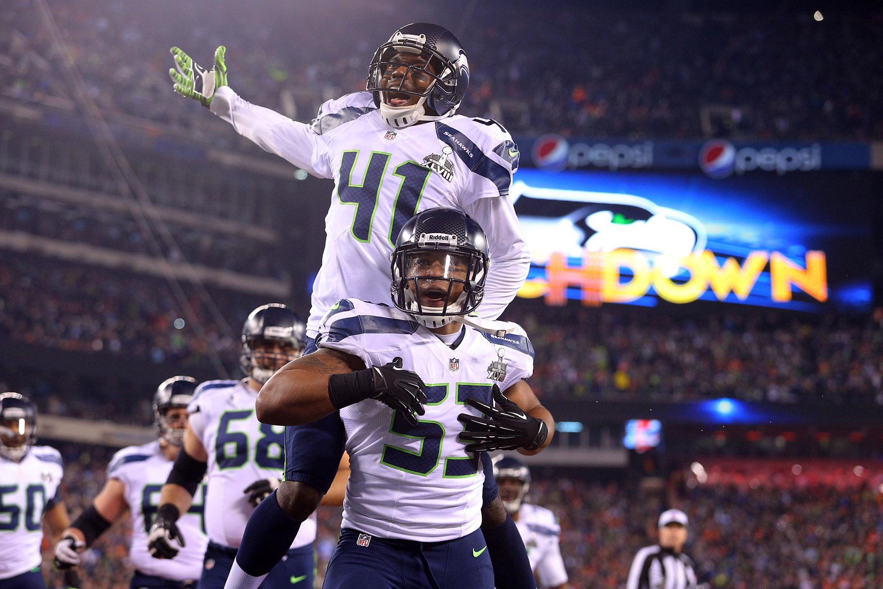 Seattle Seahawks outside linebacker Malcolm Smith and cornerback Byron Maxwell celebrate a touchdown during the second quarter.