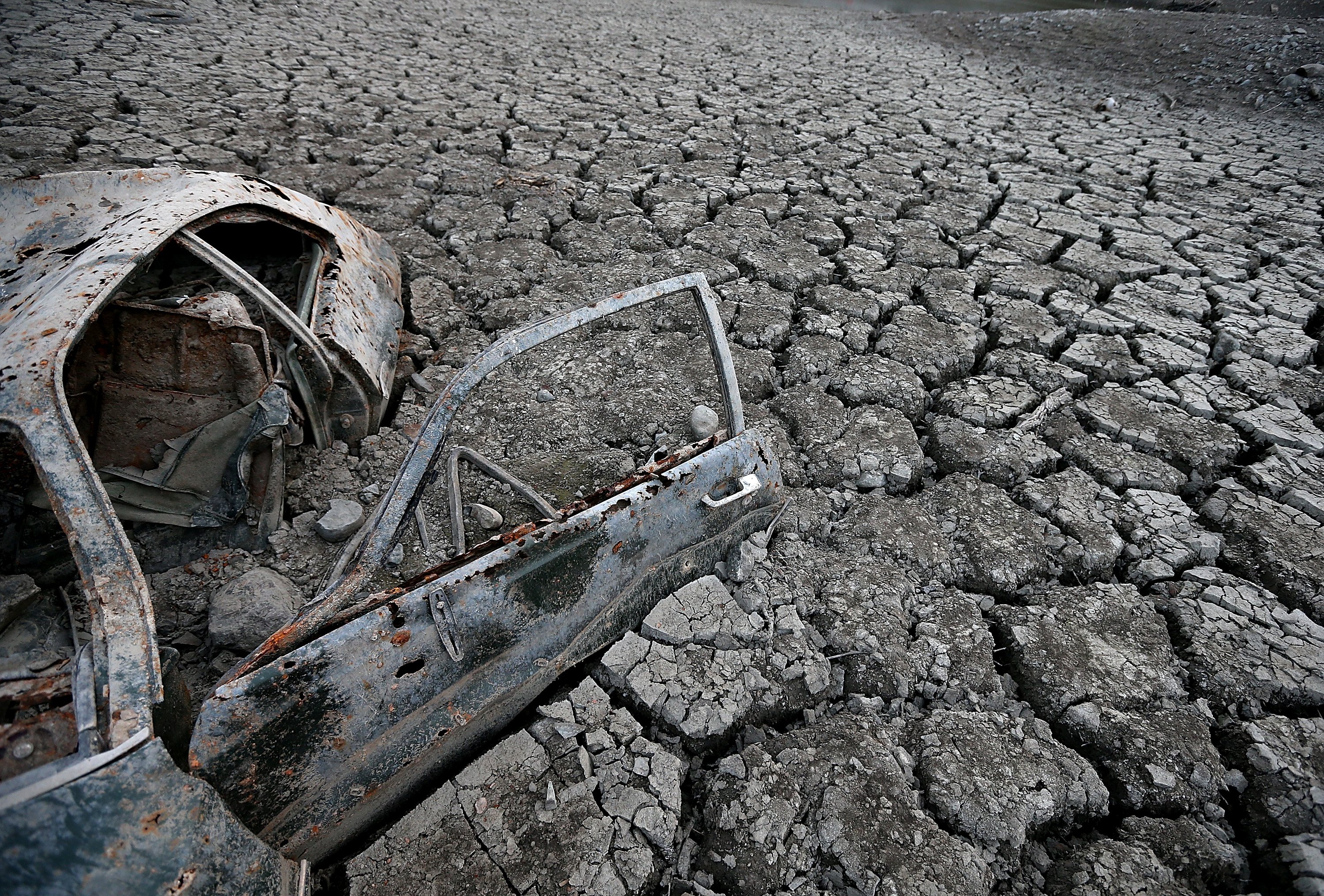 A car sits in dried and cracked earth of what was the bottom of the Almaden Reservoir on Jan. 28, 2014 in San Jose, California.