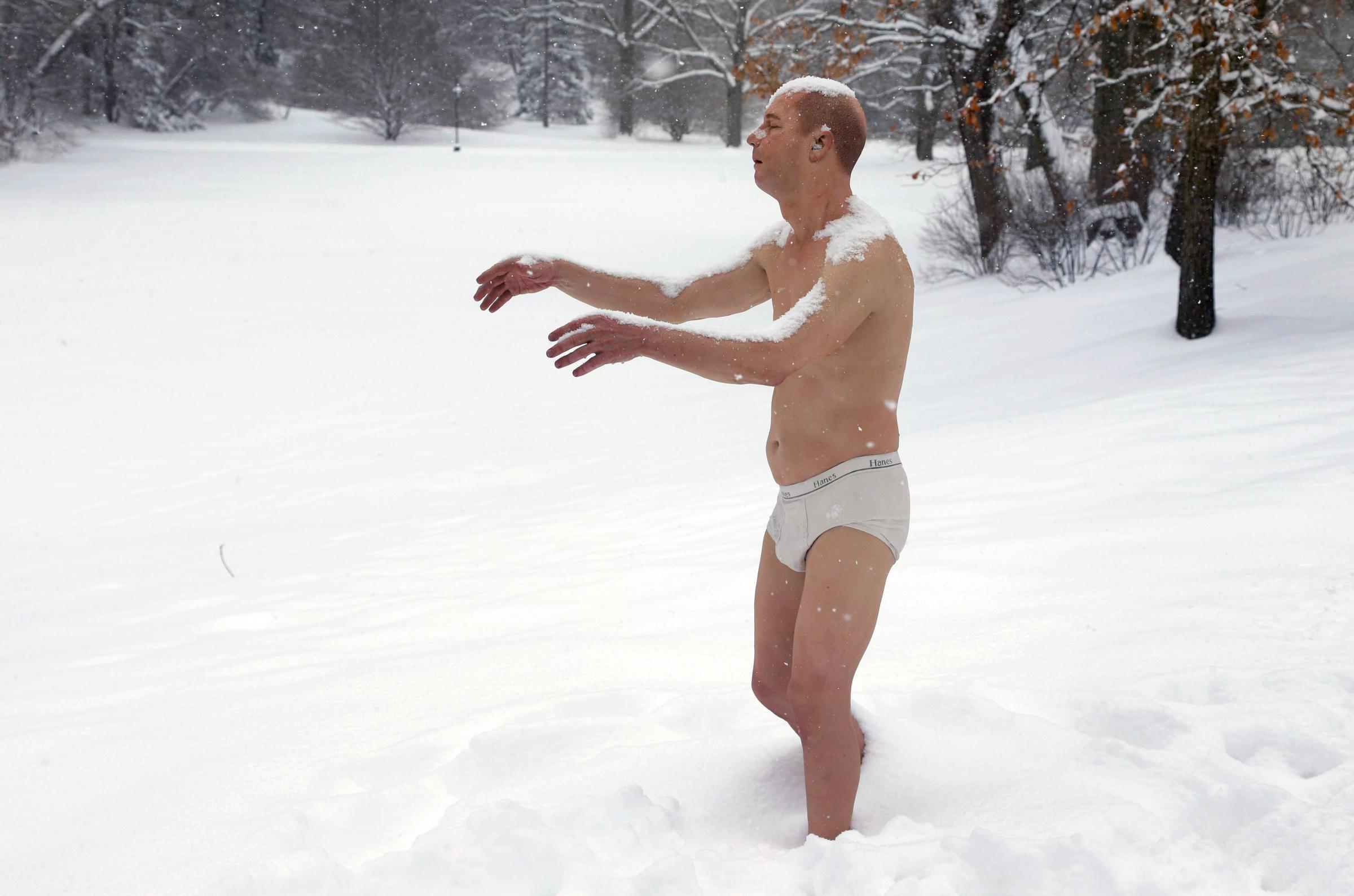 A statue of a man sleepwalking in his underpants is surrounded by snow on the campus of Wellesley College, in Wellesley, Mass., Feb. 5, 2014. The sculpture entitled "Sleepwalker" is part of an exhibit by sculptor Tony Matelli at the college's Davis Museum.