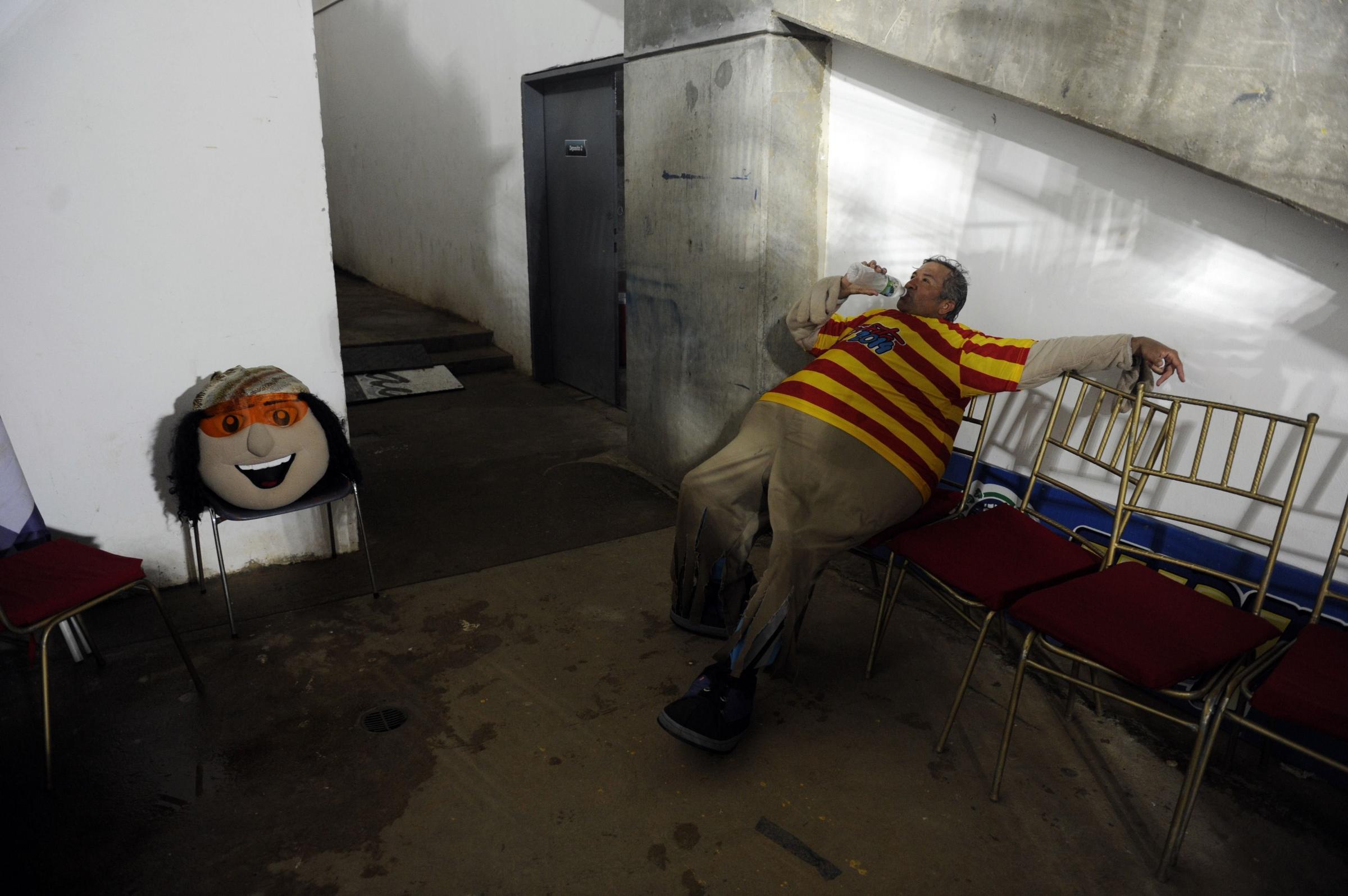 The man that works as the mascot "Margarito" for the 2014 Caribbean baseball series rests backstage during the game between Dominican Republic's Tigres de Licey and Venezuela's Navegantes del Magallanes, on Feb. 4, 2014, in Porlamar City, Margarita Island, Nueva Esparta state, Venezuela.