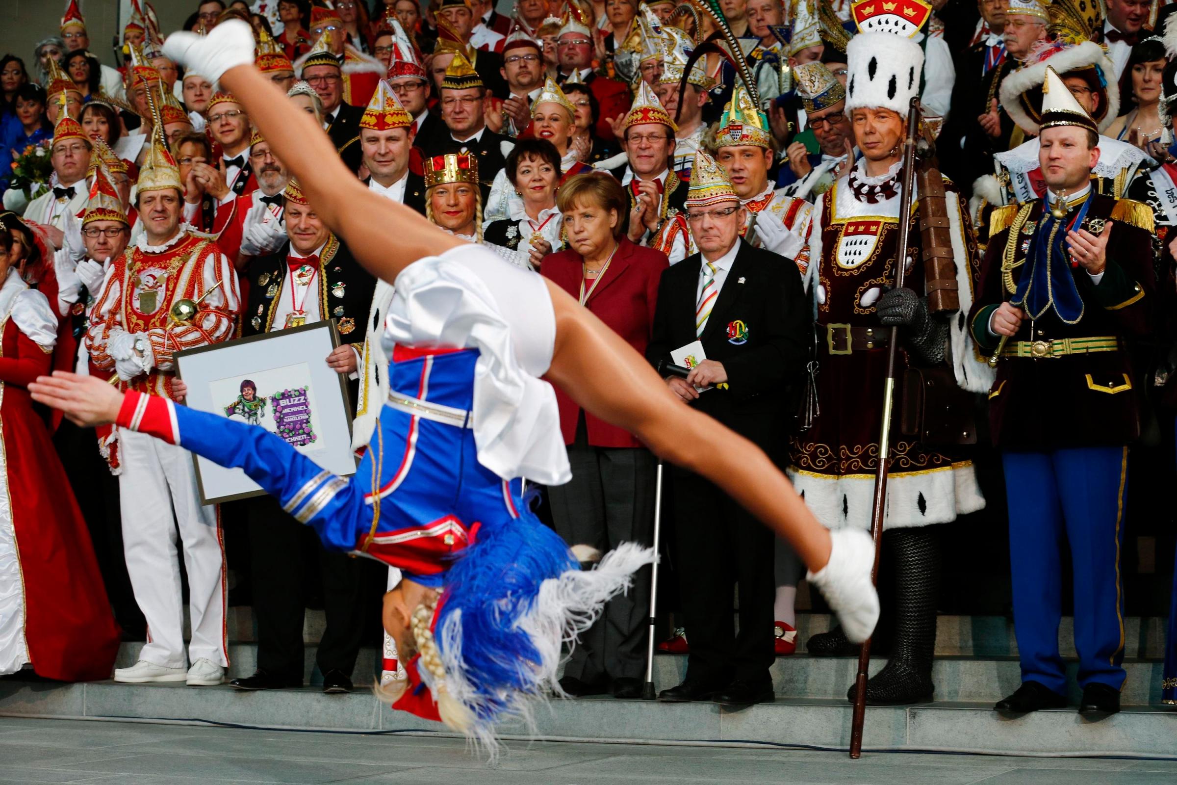 German Chancellor Angela Merkel (C) watches a dance performance by Liana Wolf during a reception of German carnival societies at the Chancellery in Berlin Feb. 18, 2014.