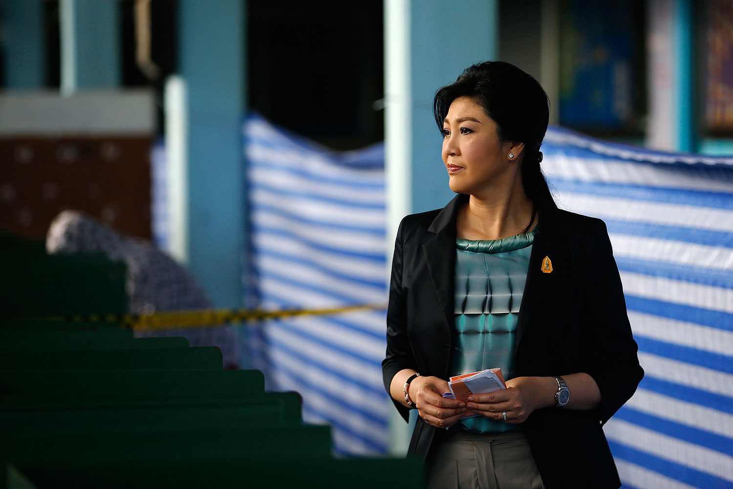 Thai Prime Minister Yingluck Shinawatra holds her ballot before casting it at a polling station in Bangkok Feb. 2, 2014 (Damir Sagolj / Reuters)