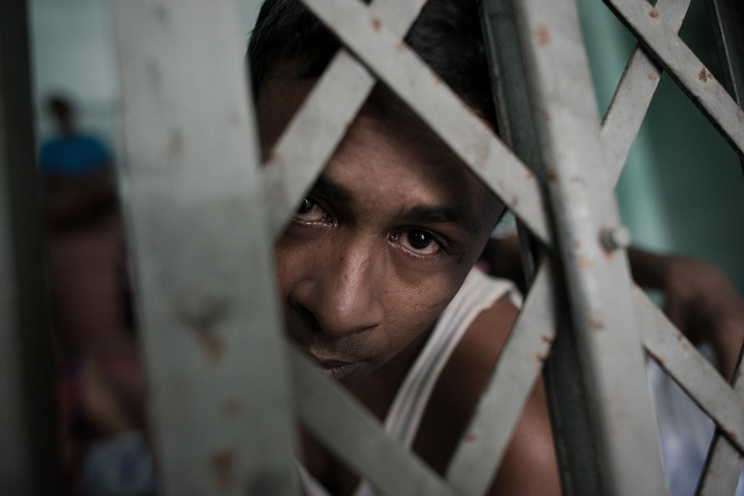 A Muslim Rohingha asylum seeker stands inside a cell at the Thai immigration detention centre in Phangnga, southern Thailand (Nicolas Asfouri—AFP/Getty Images)