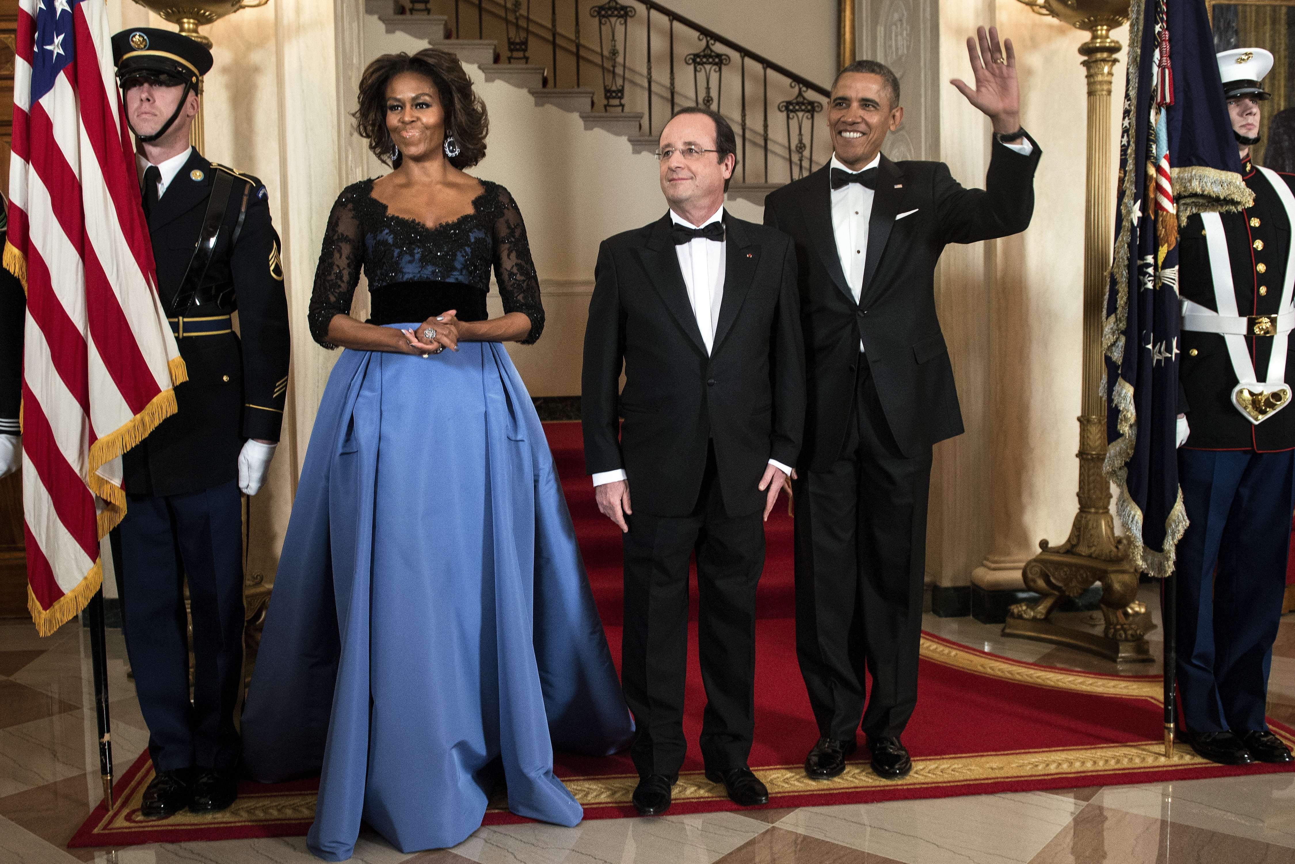 First Lady Michelle Obama, French President Francois Hollande and President Barack Obama pose in front of the Grand Staircase for an official photo before a State Dinner at the White House February 11, 2014 in Washington. (Brendan Smialowski—AFP/Getty Images)