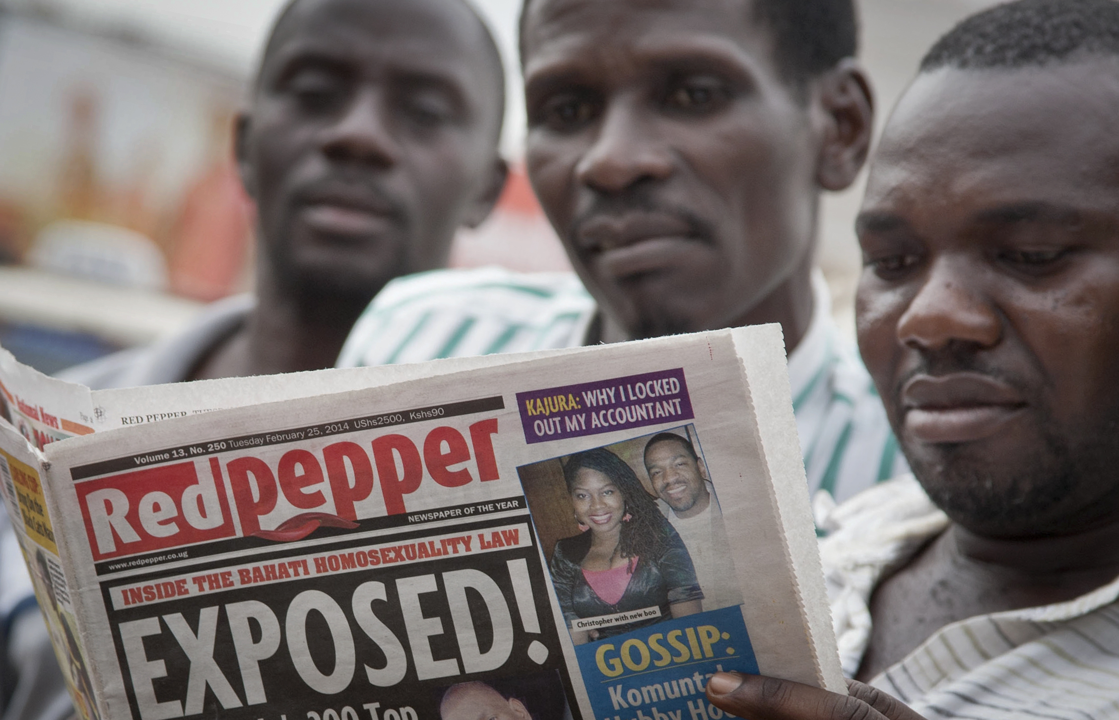 A Ugandan reads a copy of the "Red Pepper" tabloid newspaper in Kampala, Uganda Tuesday, Feb. 25, 2014. (Rebecca Vassie—AP)